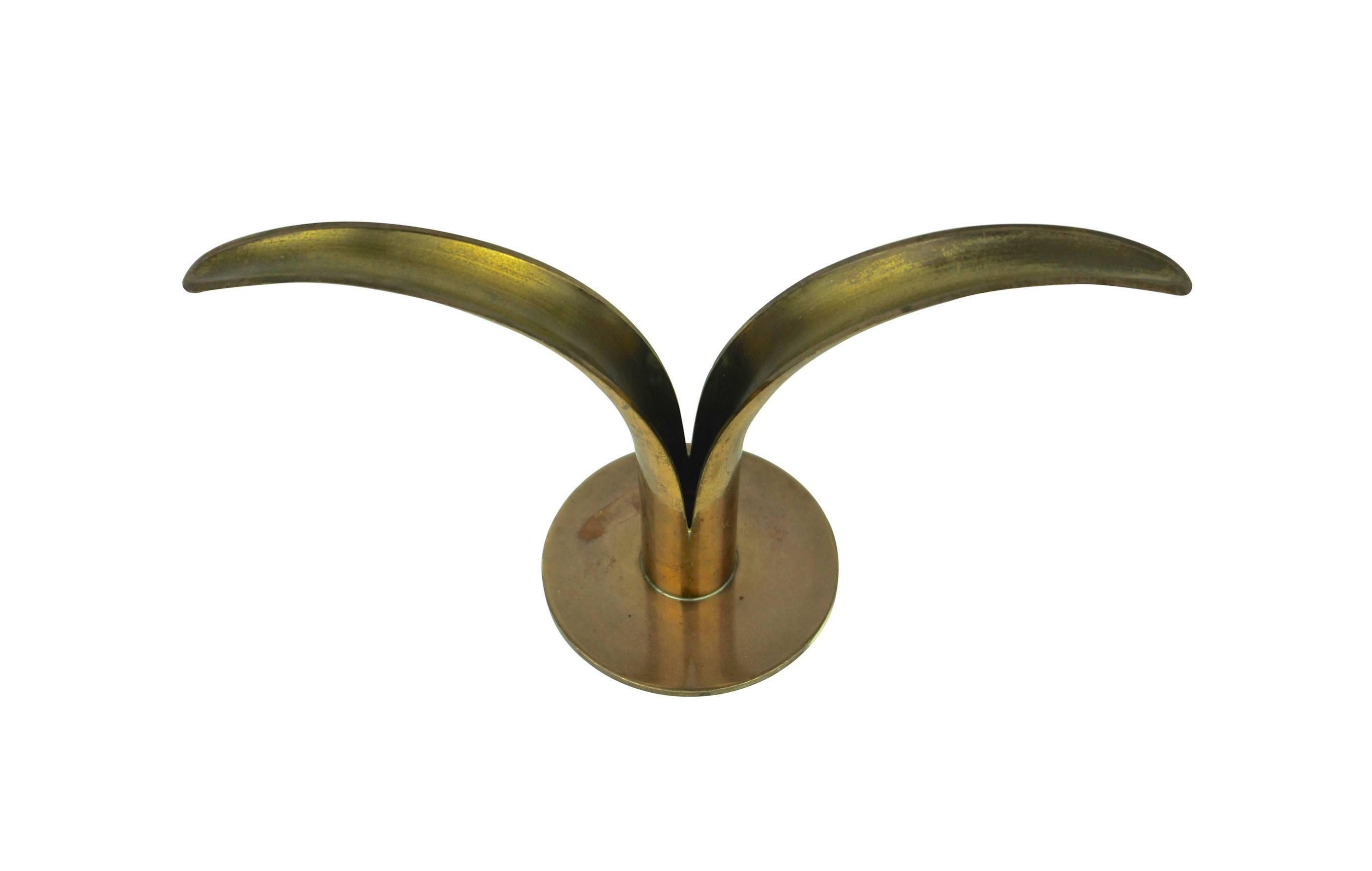 A brass candle holder designed by Ivar Ålenius Björk "Lily", produced by Ystad Metall in Sweden. In beautiful original patinated condition.