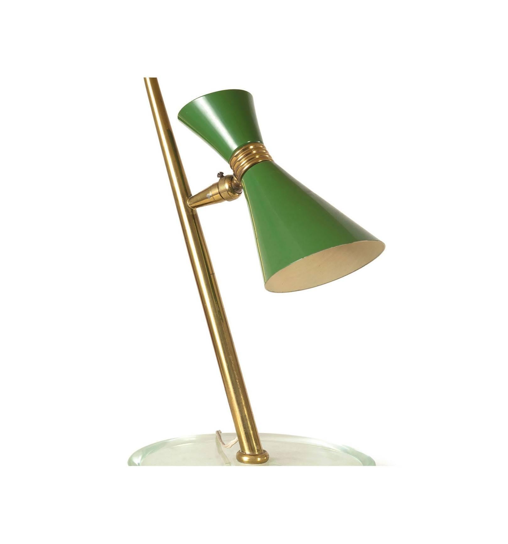A beautiful table lamp in the style of Fontana Arte diabolo-shaped lamp shade with glass base.