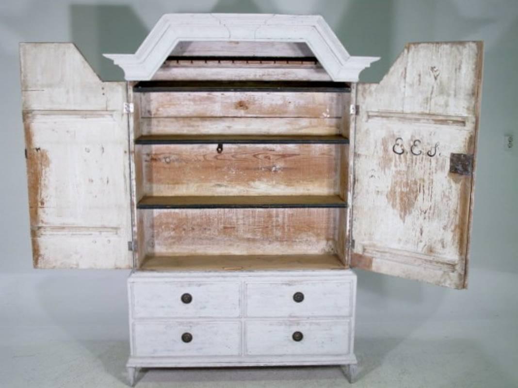Swedish antique 19th century Gustavian narrow cabinet on tapered feet with two doors and four drawers.