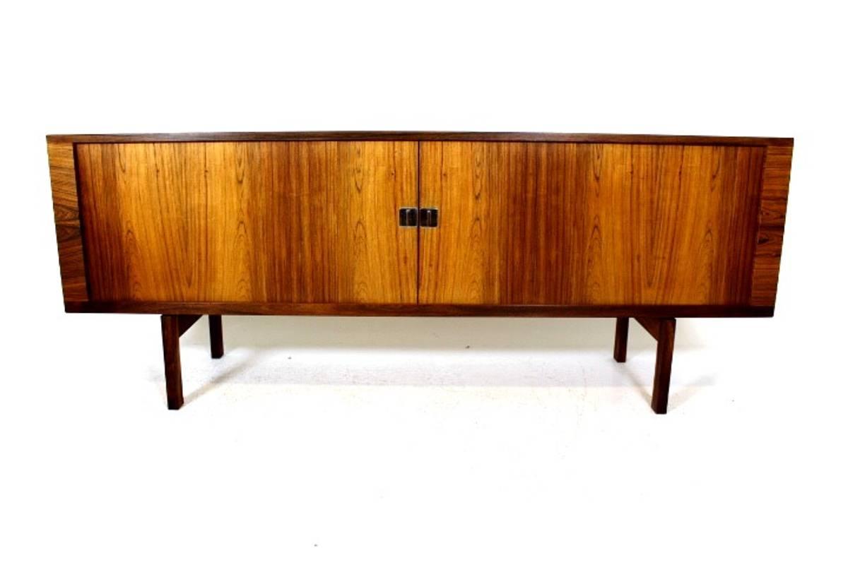 A rosewood credenza/sideboard designed by Hans J. Wegner for Ry Møbler. The sideboard has tambour doors. Interior is in soaped oak. Danish furniture control mark on the inside and Ry Møblers mark on the back.