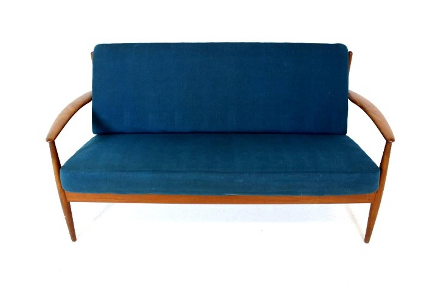 Vintage Danish teak framed two-seat sofa designed by Grete Jalk for France & Daverkosen in the 1960s.
This lovely two-seat sofa is both a delight to look at and to lounge on with its single sprung cushion seat and back.
The cushions have the