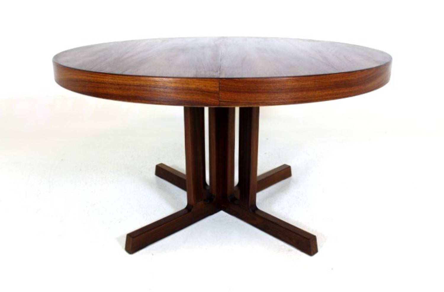 Rare Danish modern rosewood expandable pedestal table. Attributed to the Danish designer Kai Kristiansen The grain on top of the table is stunning and matched in the extensions. When the table is fully extended, oval, W 188 cm, D 128 cm, H 74 cm.