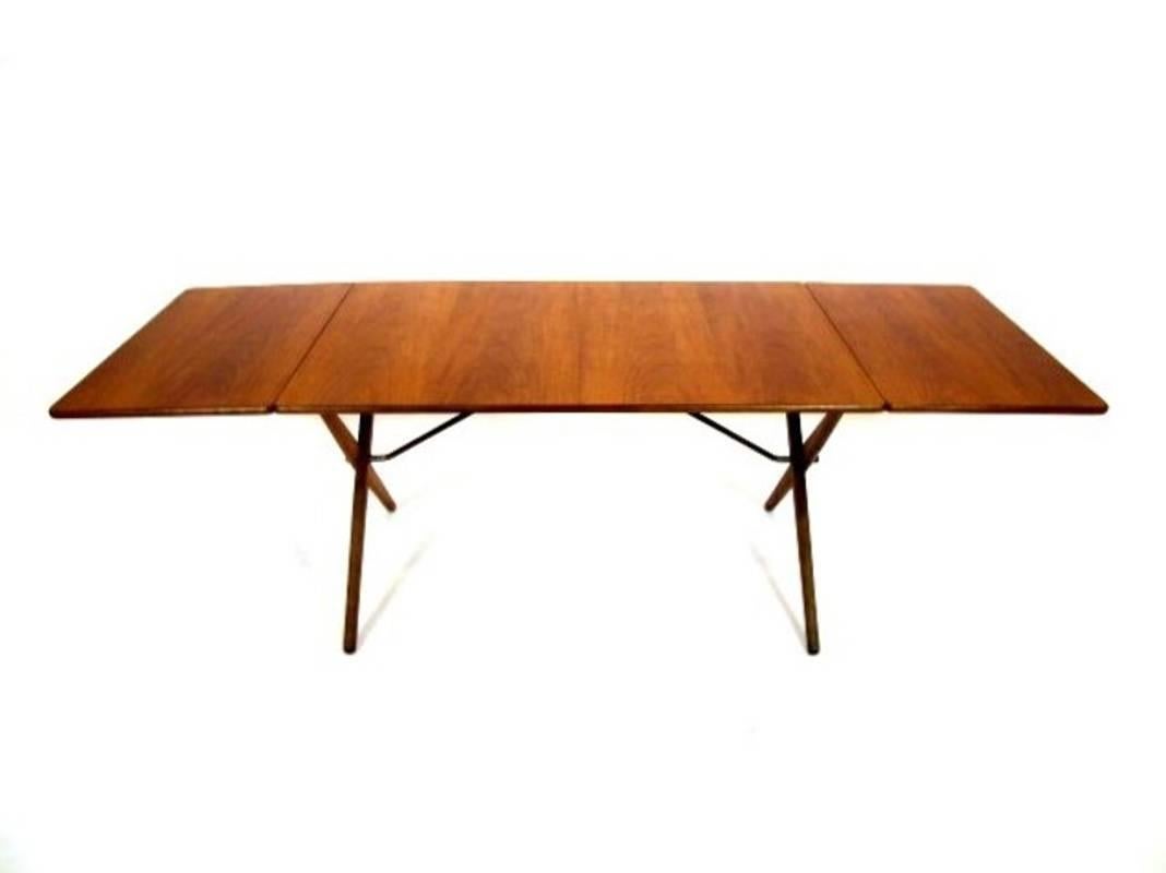 Great dining table, designed by Hans J. Wegner 1952, Model AT-309. Manufactured by Andreas Tuck. Top in teak and legs in solid oak with brass trust base. Stamped with designer and maker. Great condition.
Measures: 128 + 50 + 50 = 228 cm long.