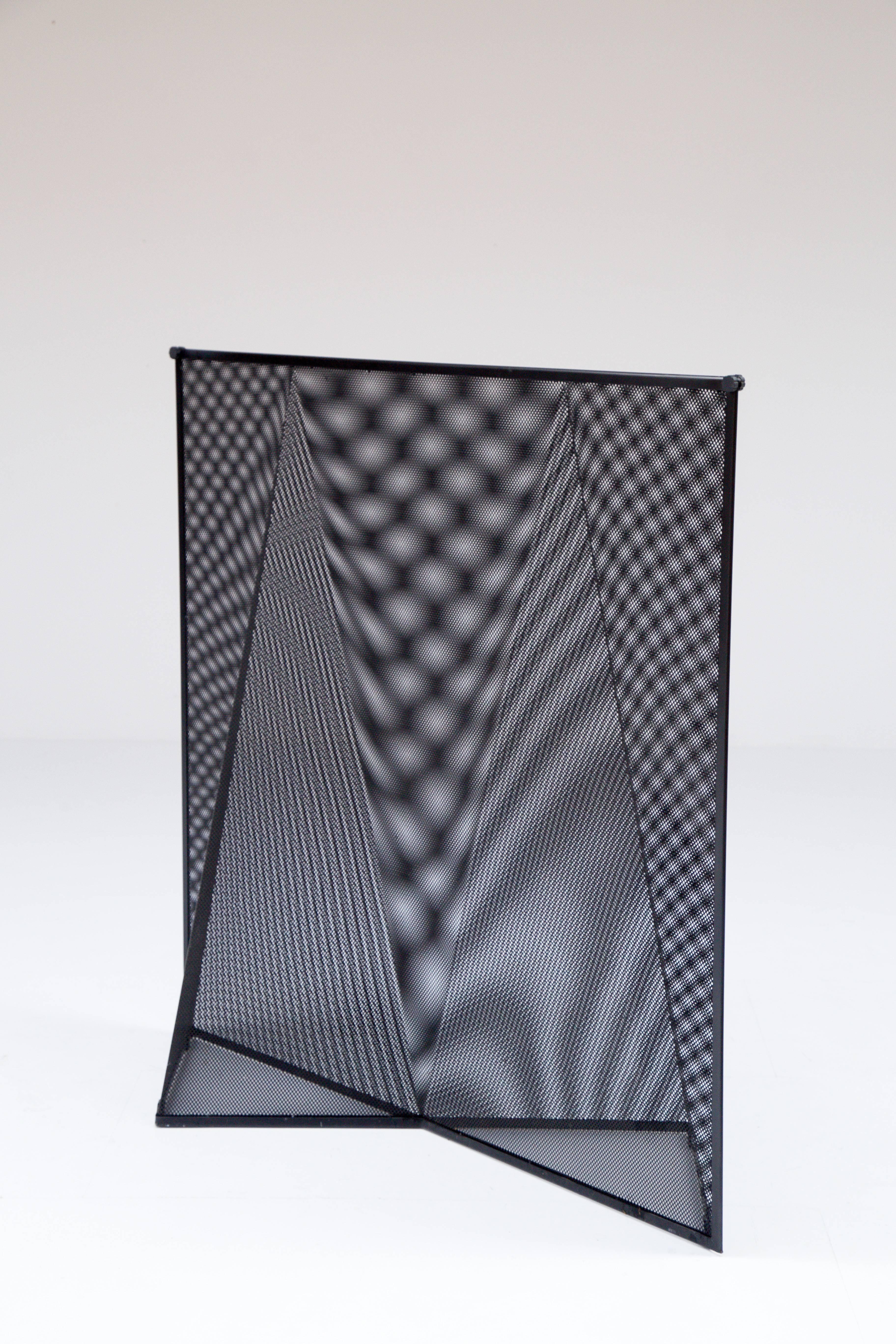 The Nilla Rosa screen designed in 1990s by Swiss architect Mario Botta and produced by Alias, Italy. Perforated and stretched steel frames enameled in black creating an Op-art effect due to the juxtaposition of the frames.