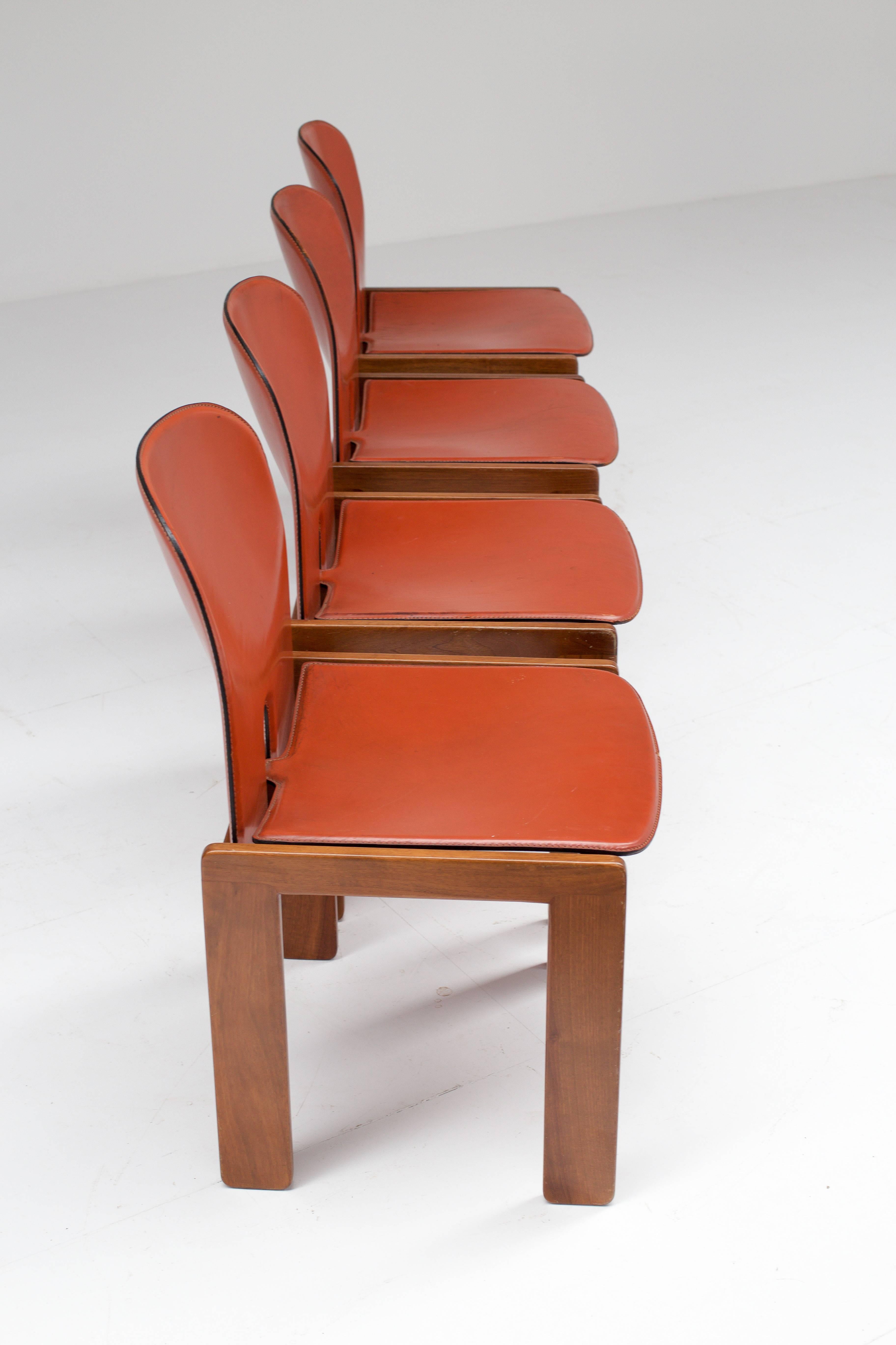 Set of four chairs model 121 with makers mark, designed in 1965. There is a very nice subtle patina to the leather which remains in an almost perfect condition. The wood frame is also in very good condition.