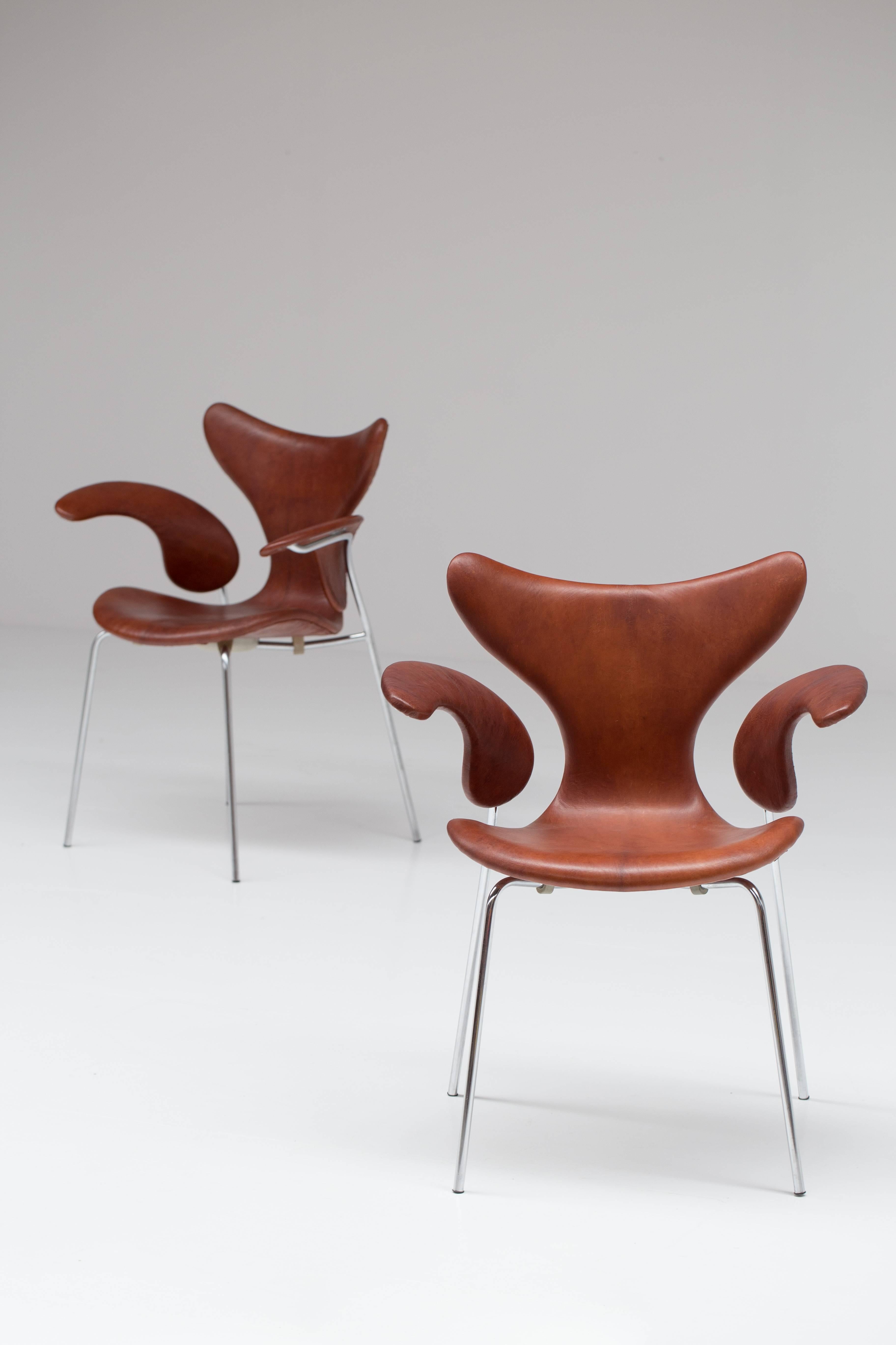 Pair of rare original leather Arne Jacobsen armchairs named and known as 'Seagull'. 
Manufactured by Fritz Hansen, marked '1970'. The leather is just fantastic.