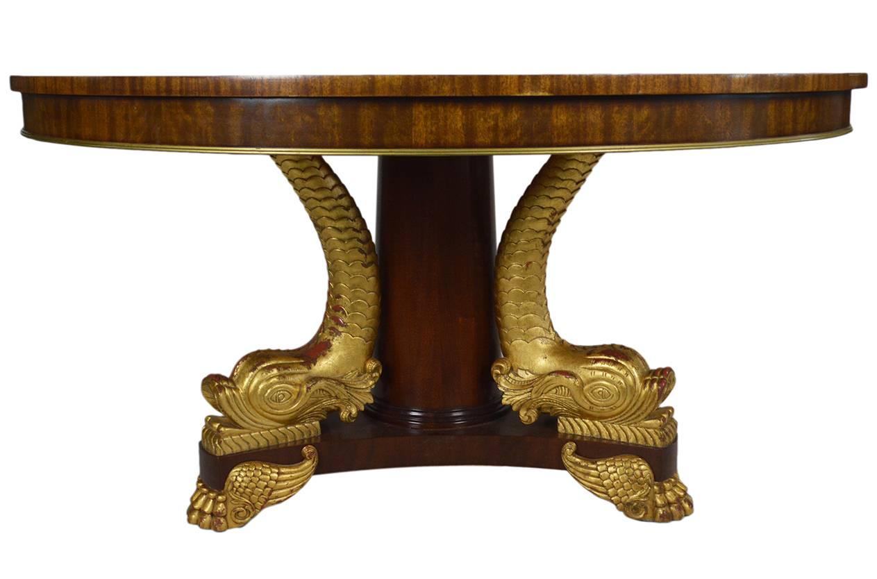 Vintage dining table with pedestal base adorned with gold leaf koi fish motif. The top features an intricate marquetry inlay with banded edged and gold trim. It comes in two pieces with top bolted to the base.