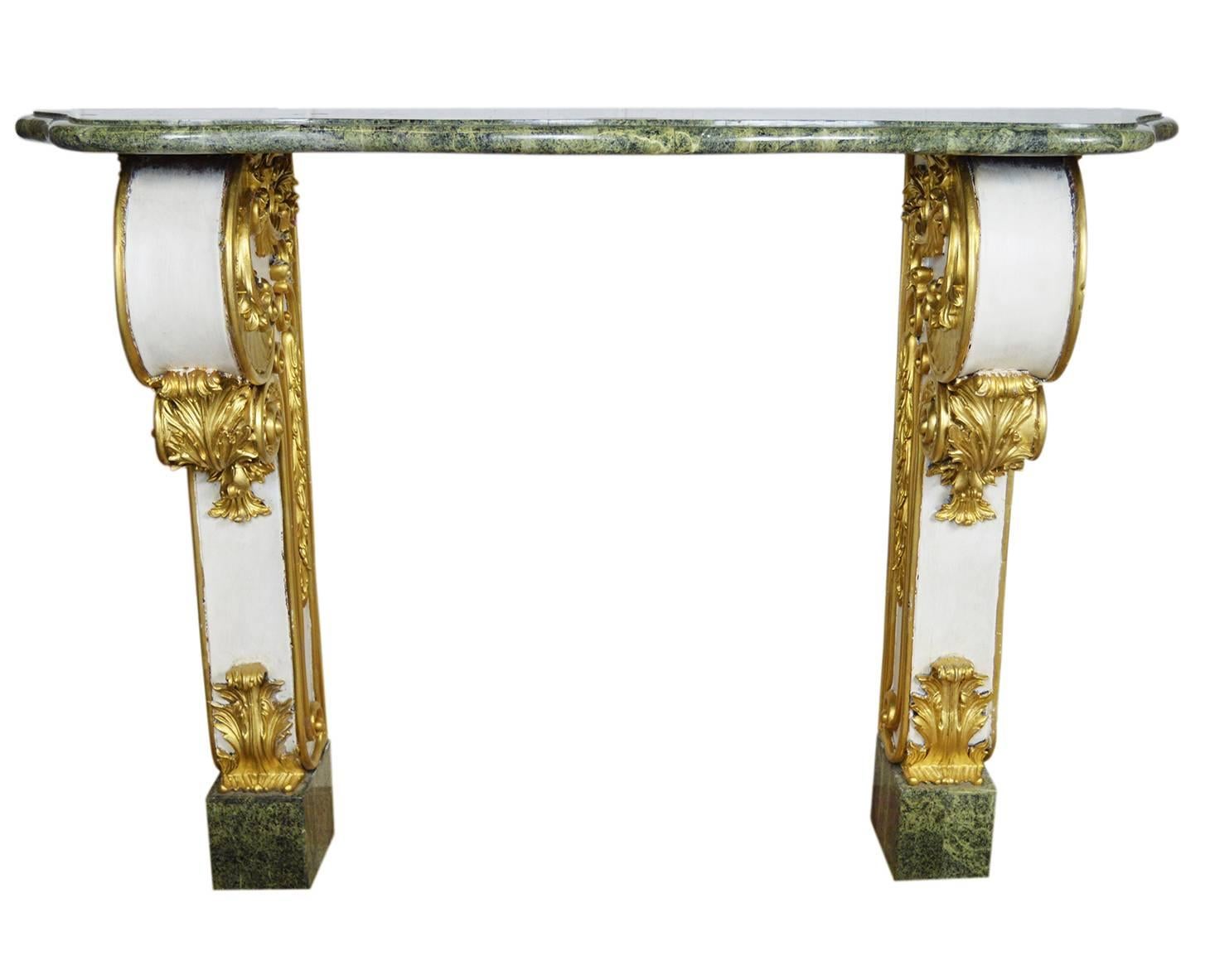 Vintage French marble top console. The green marble rests on French fragment bases adorned with gilt scroll and foliate styling. Holes in the back to mount to wall.
