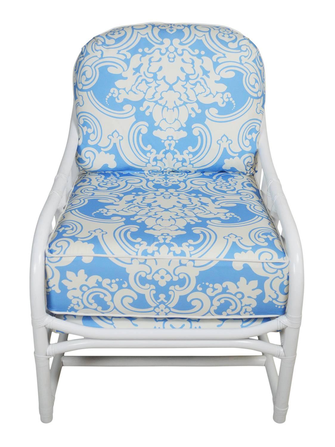 Ficks Reed lounger newly lacquered in white. The rattan frame has gentle sloping arms and leather windings. The new removable cushions and seat frames are upholstered in Scalamandre damask designer fabric.