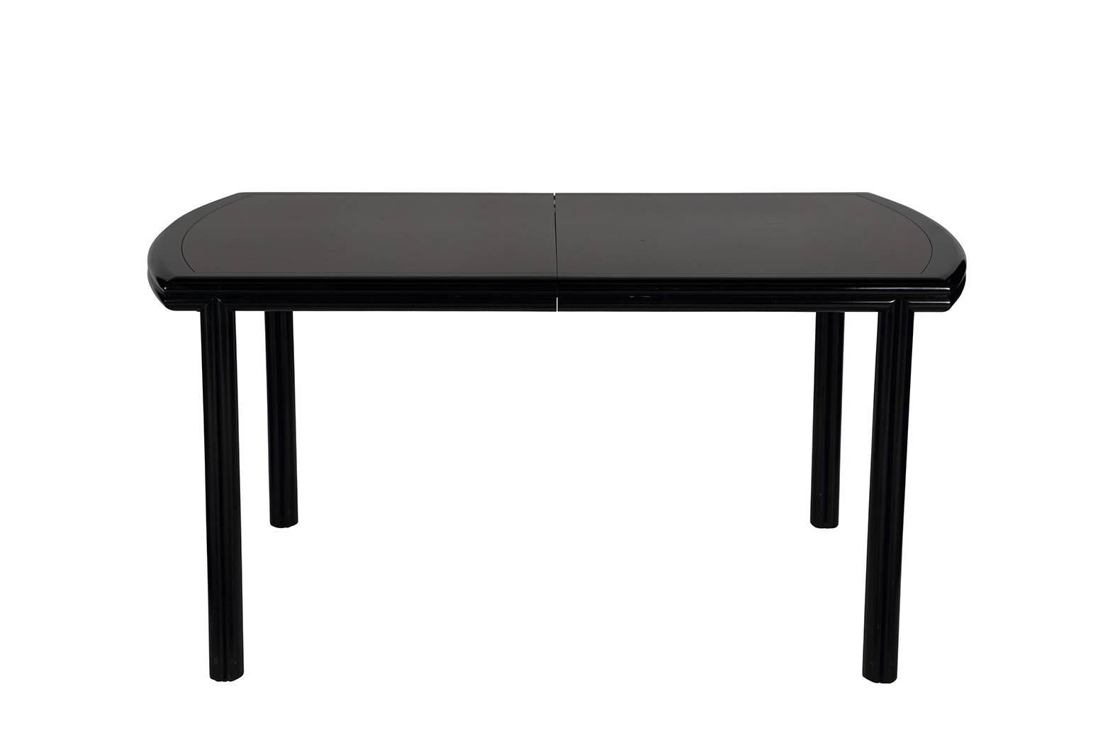 Vintage glossy black lacquered dining table with brown wood inlay. The piece has two leaves (18