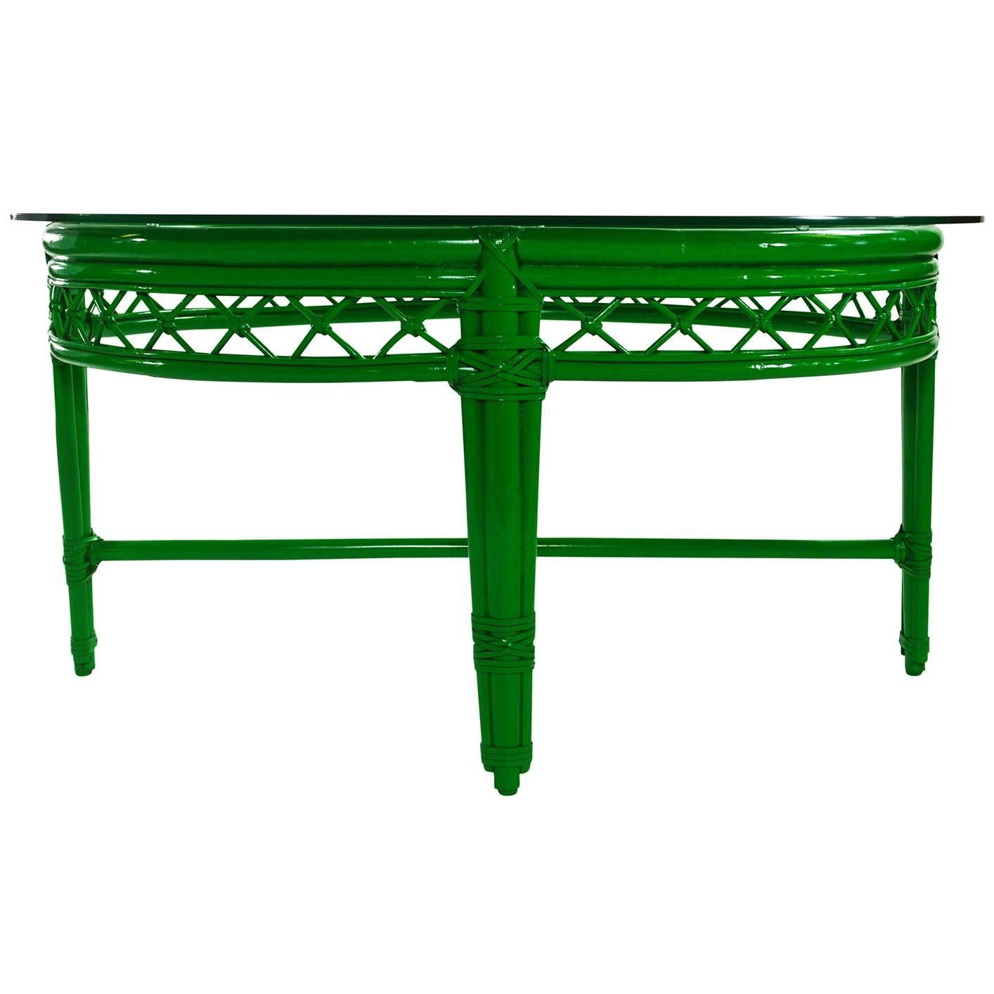 Ficks Reed cocktail or coffee table newly lacquered in green with new customer glass top. The table has a rattan frame and lattice apron with leather windings.