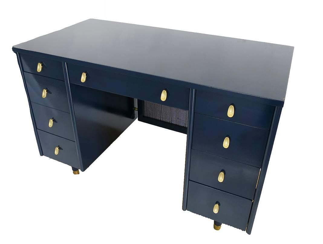 Vintage Mid-Century Modern desk newly lacquered in a rich navy. The piece has four drawers on the right, three on the left and one centre adorned with brass hardware. Marked Sligh-Lowry.
