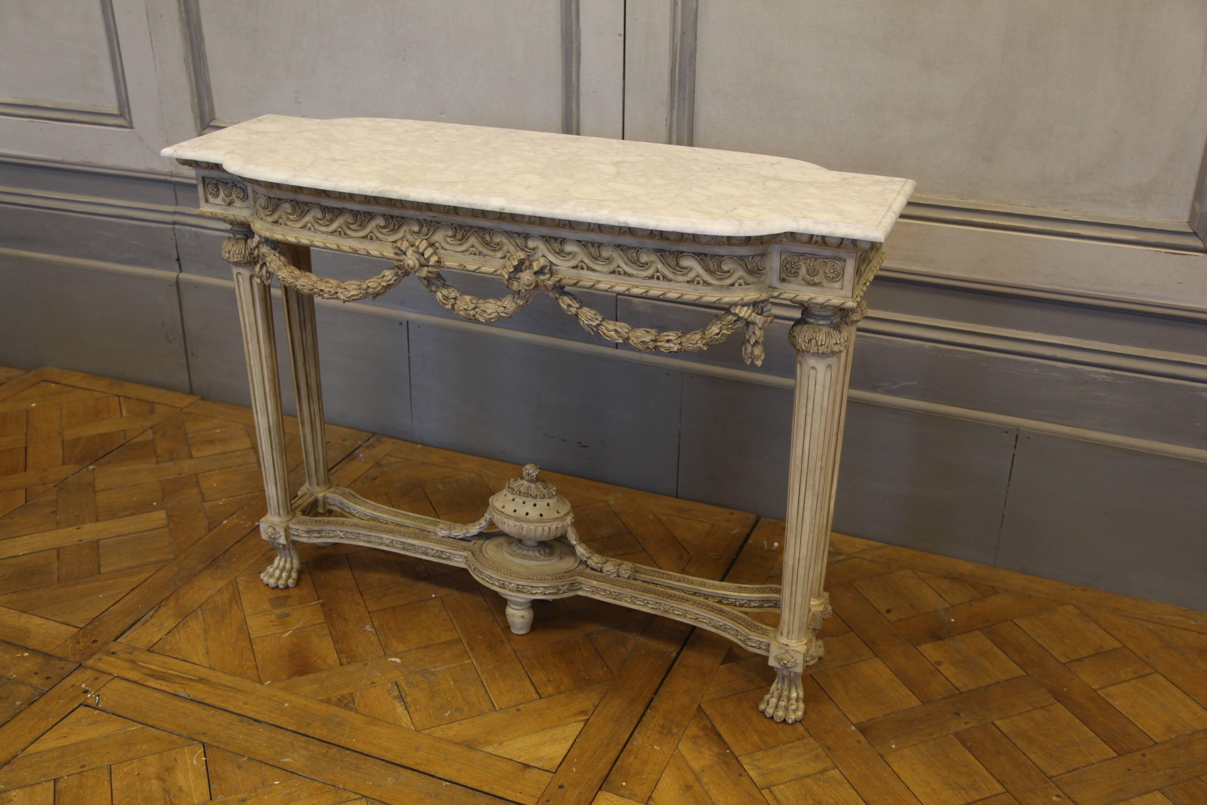 Louis XVI style freestanding console: Hand-carved on both sides by master craftsmen and hand finished in an aged, ecru white patina, made using traditional methods and materials. Beveled Carrara marble top as seen in pic.