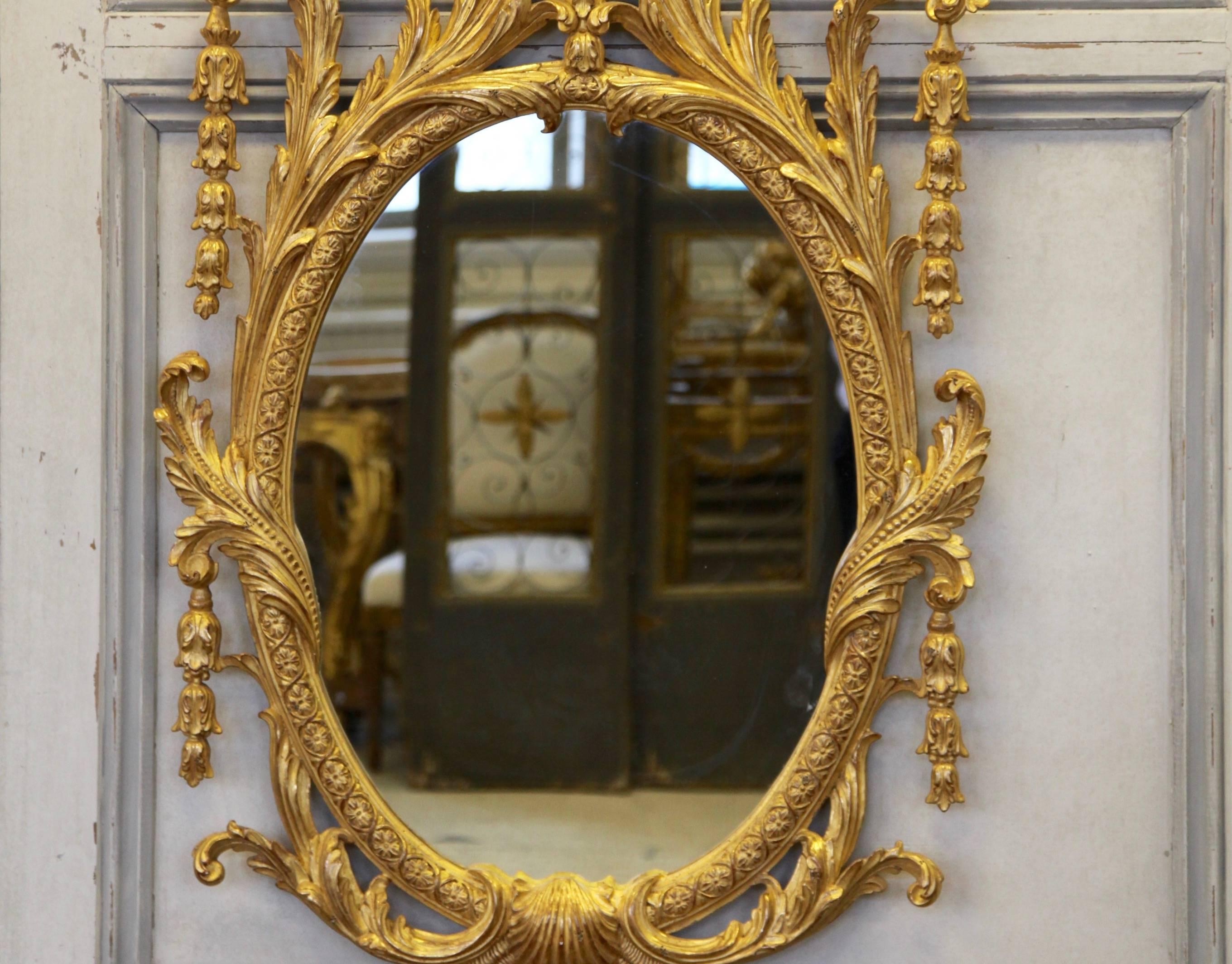English George IV style Mirror from an original design attributed to John Vardy: hand-carved by master craftsmen in an aged, water gilded finish made using 23.75 carat gold leaf. Picture shows one of a pair available. Can be sold individually or as