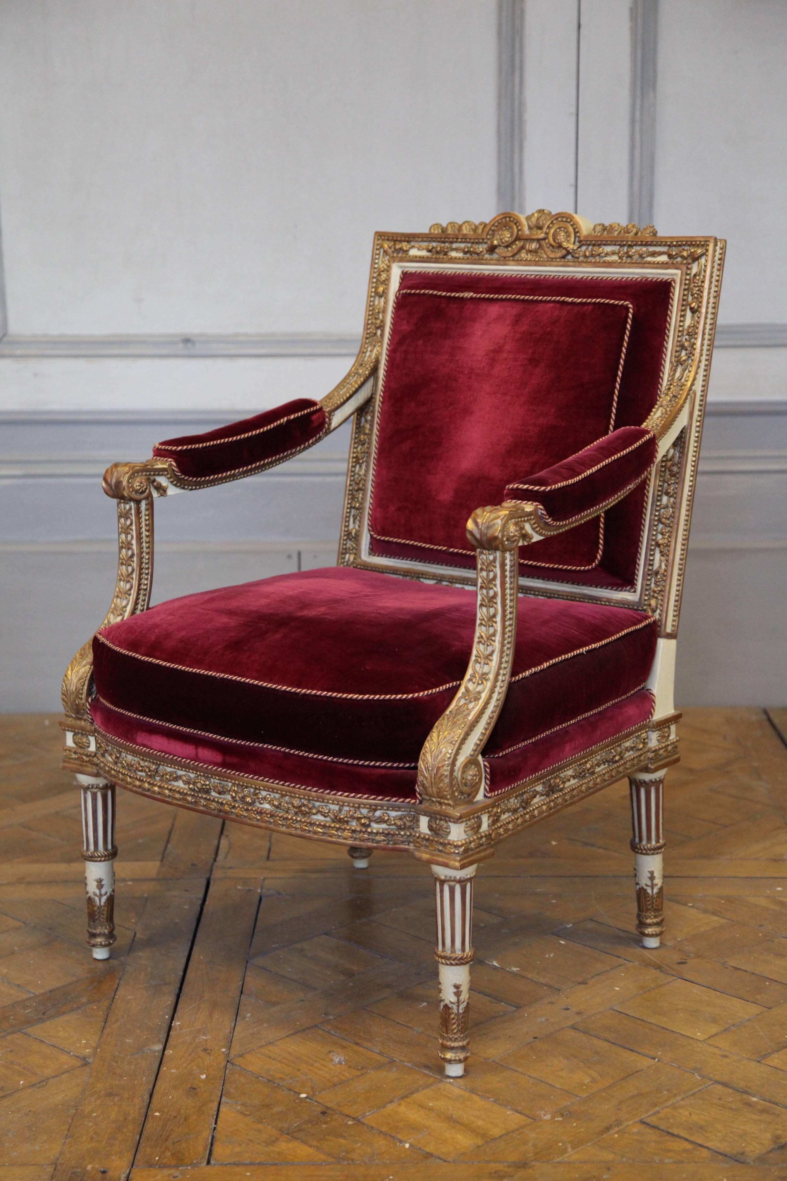 Louis XVI style armchair: Picture shows one of a pair which were made as a one off by master craftsmen. Elegantly carved and hand finished in a two tone patina, gilded or ecru, slightly aged. Made using traditional methods and materials. Upholstered