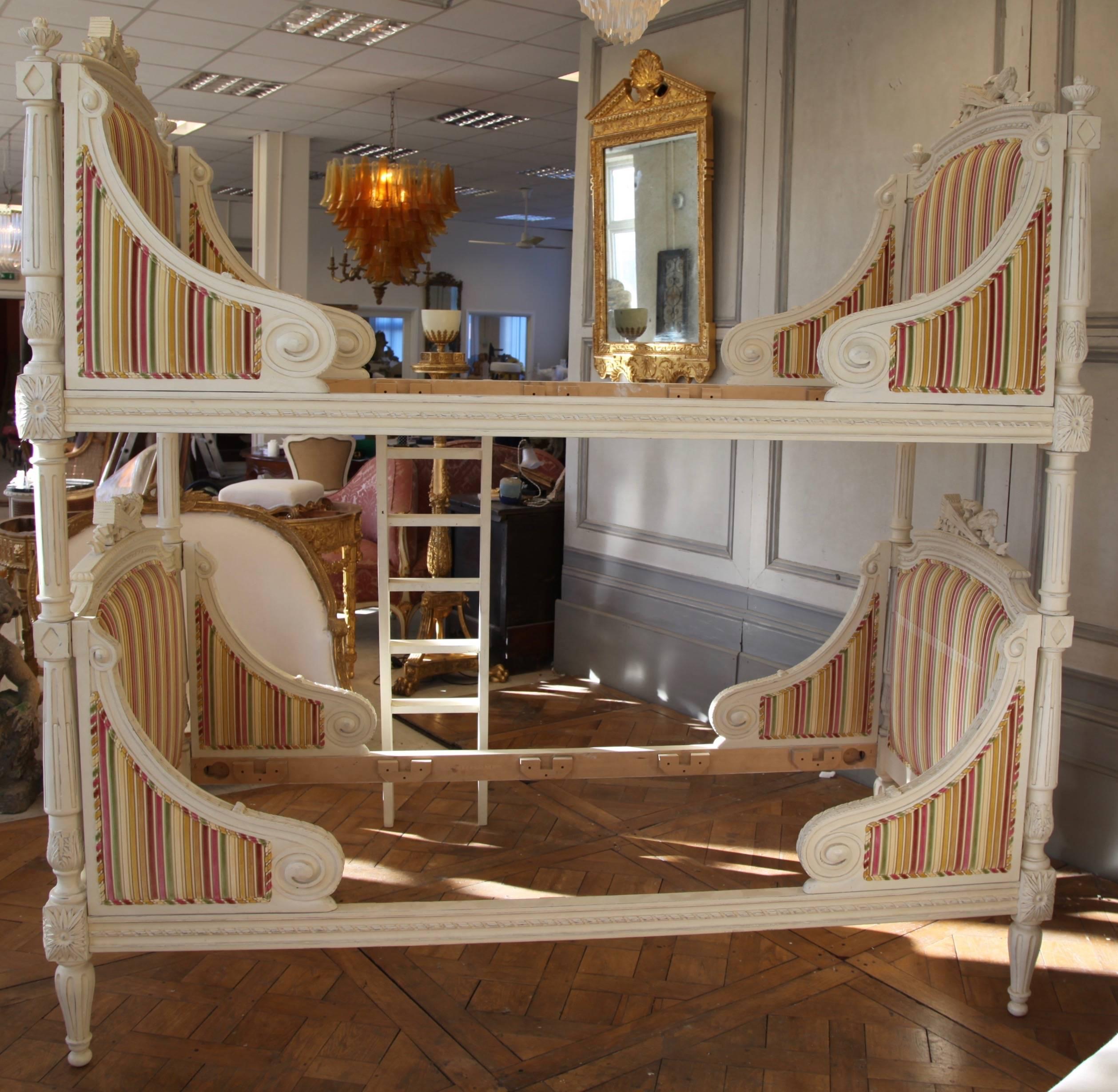 Louis XVI style bunk beds, hand-carved and hand finished in an off-white, antique finish. Takes a mattress size: 90cm x 200cm (3ft x 6ft6'). The beds come with an extra set of legs, finials and columns so they can also be set up as a matching pair