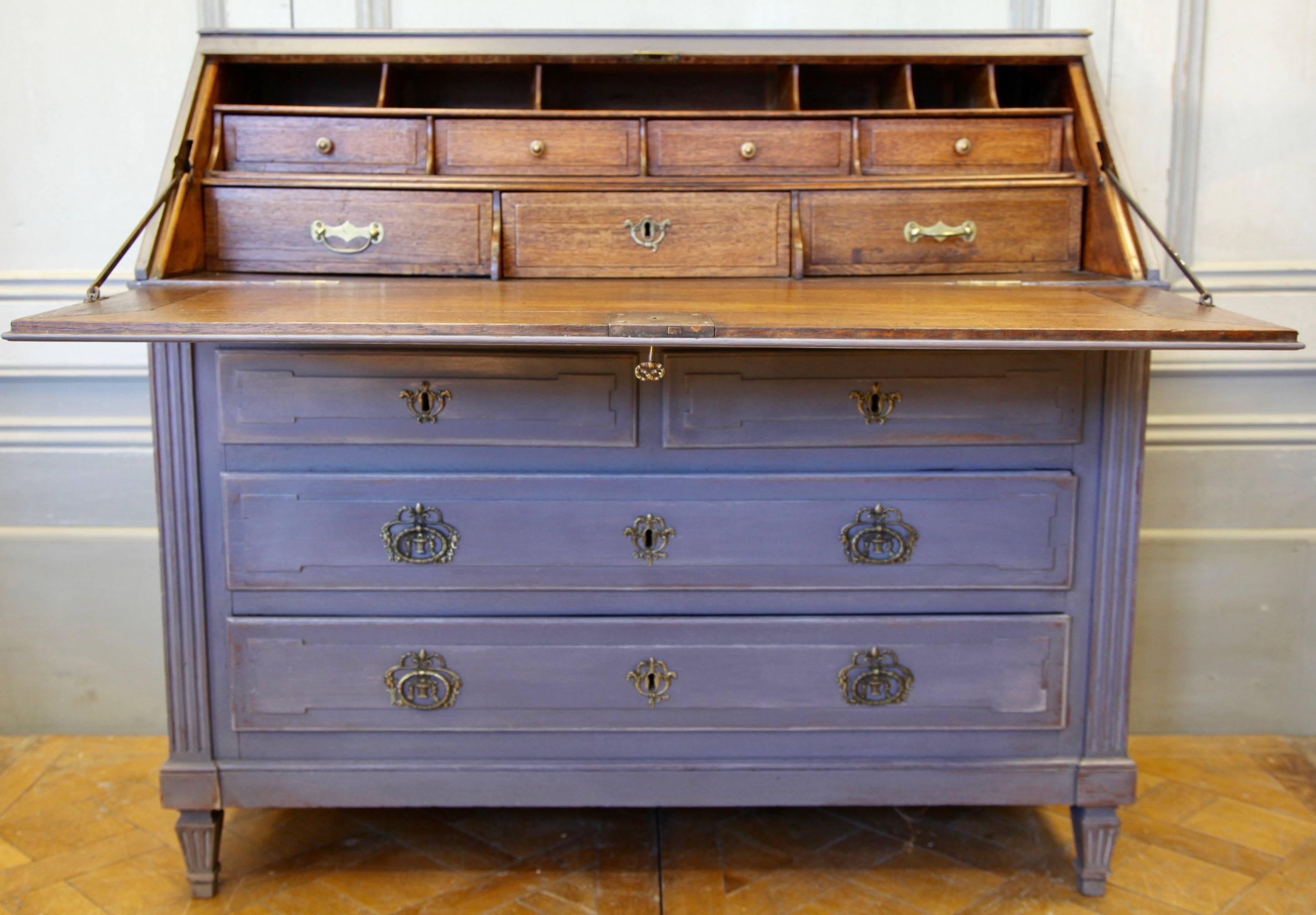 An elegant, beautifully made 18th century French Scribban in solid oakwood. The interior of the desk has a polished, natural, wood patina and the outside is finished in an age distressed paintwork. All the bronze work is original to the piece.