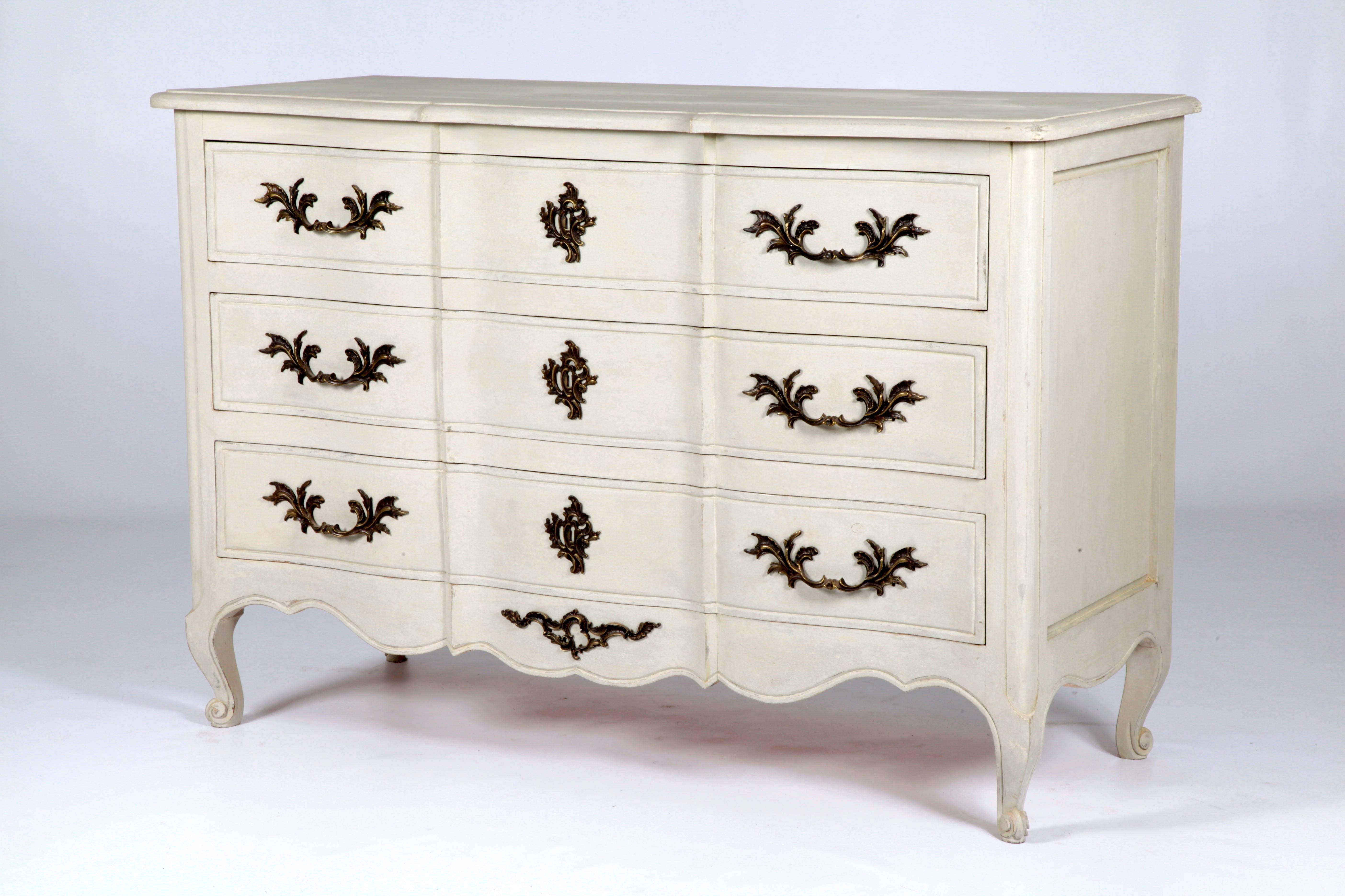 French Regence style chest of drawers handmade in solid wood with bronze ormolu mounts which have been treated to achieve an antique grey patina. The drawers are finished in a French grey patina which has been slightly aged and distressed.