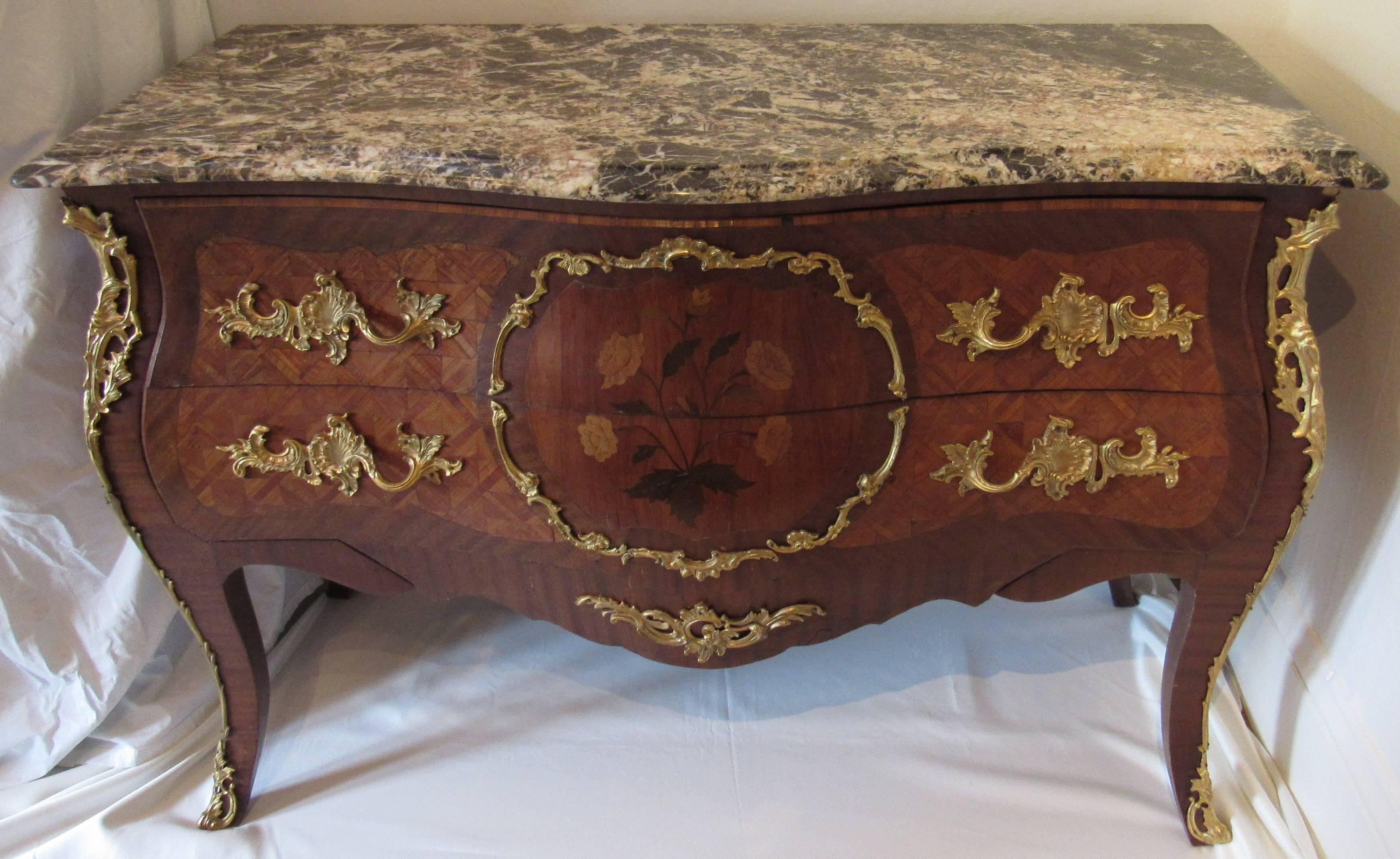 French marquetry inlaid Bombay chest with two large drawers. 

Floral and diamond patterned inlays and ormolu mounts. Grey and salmon marble top, 

circa 1840. 

Measures: 51” width, 21” depth, 36” height.
 