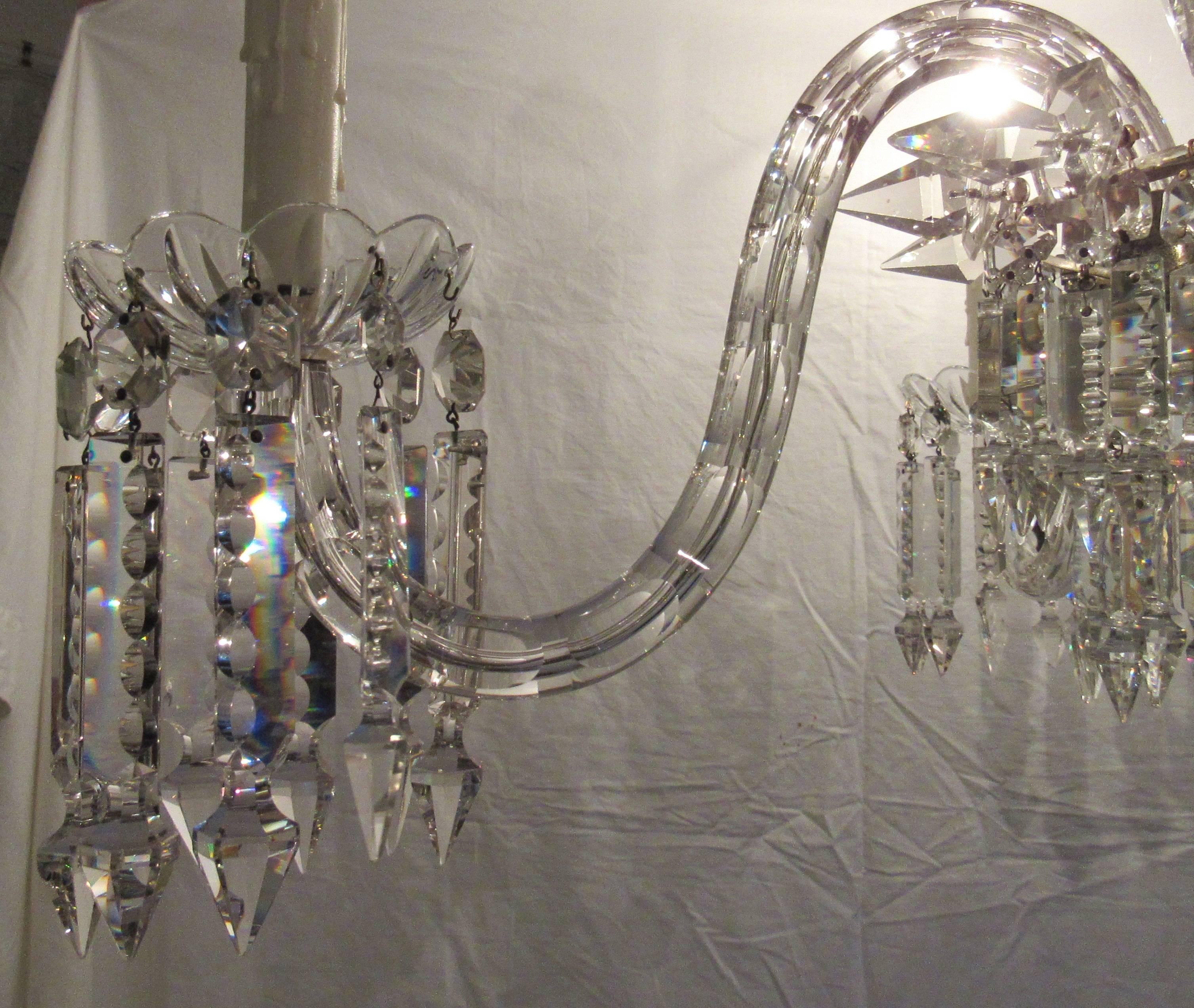 Gorgeous European crystal chandelier, early 20th century. 

Two sections of hanging prisms down to the center basket with three graduating rings of prisms with center ball top accented with crystal spears. Four cut-glass arms with hanging