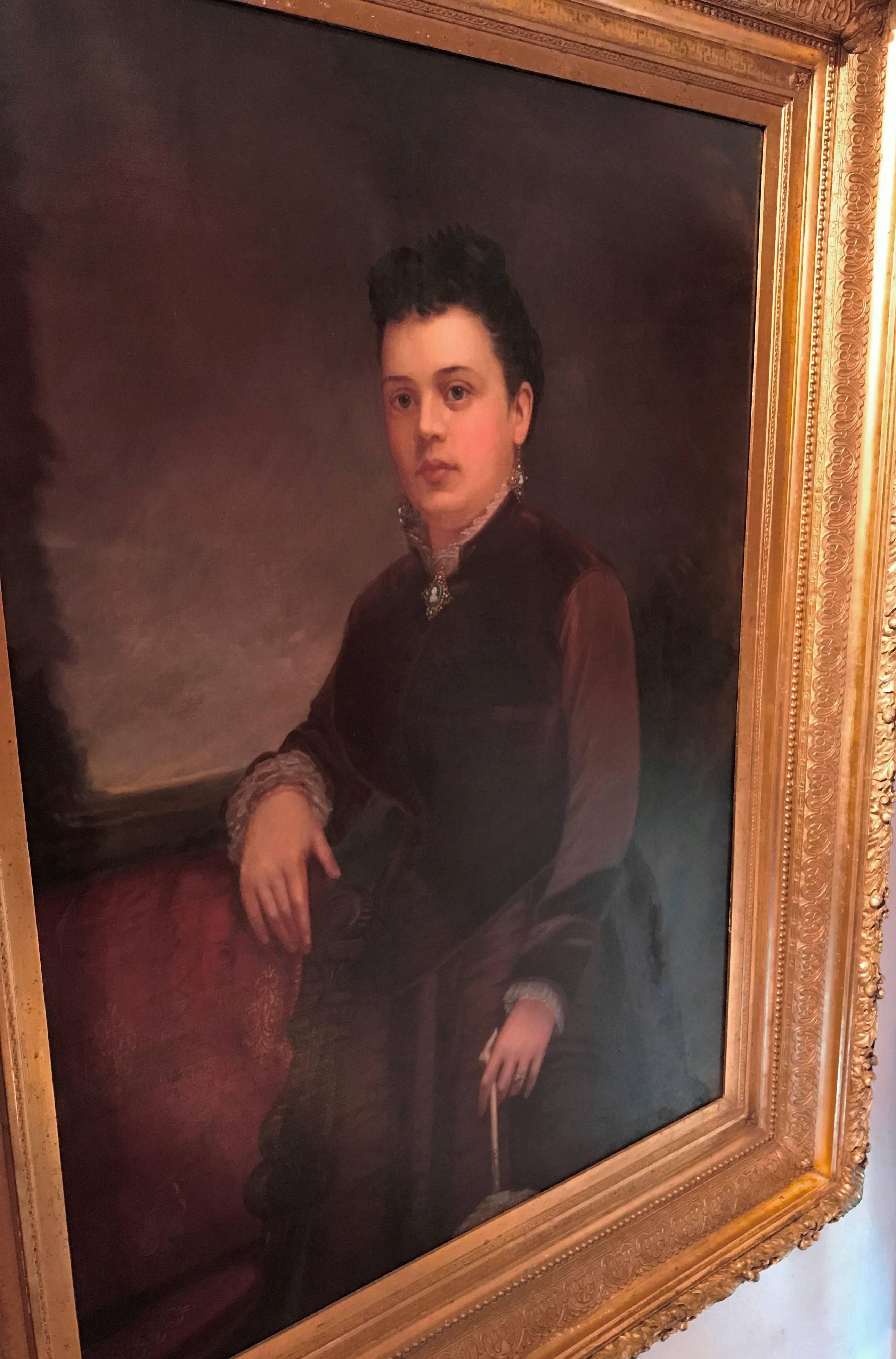Original oil painting on canvas of a Victorian California socialite standing next to settee wearing period jewelry.

Artist signed William Cogswell and dated 1877. Painted during his time in San Francisco, Los Angeles, and Pasadena. He painted many