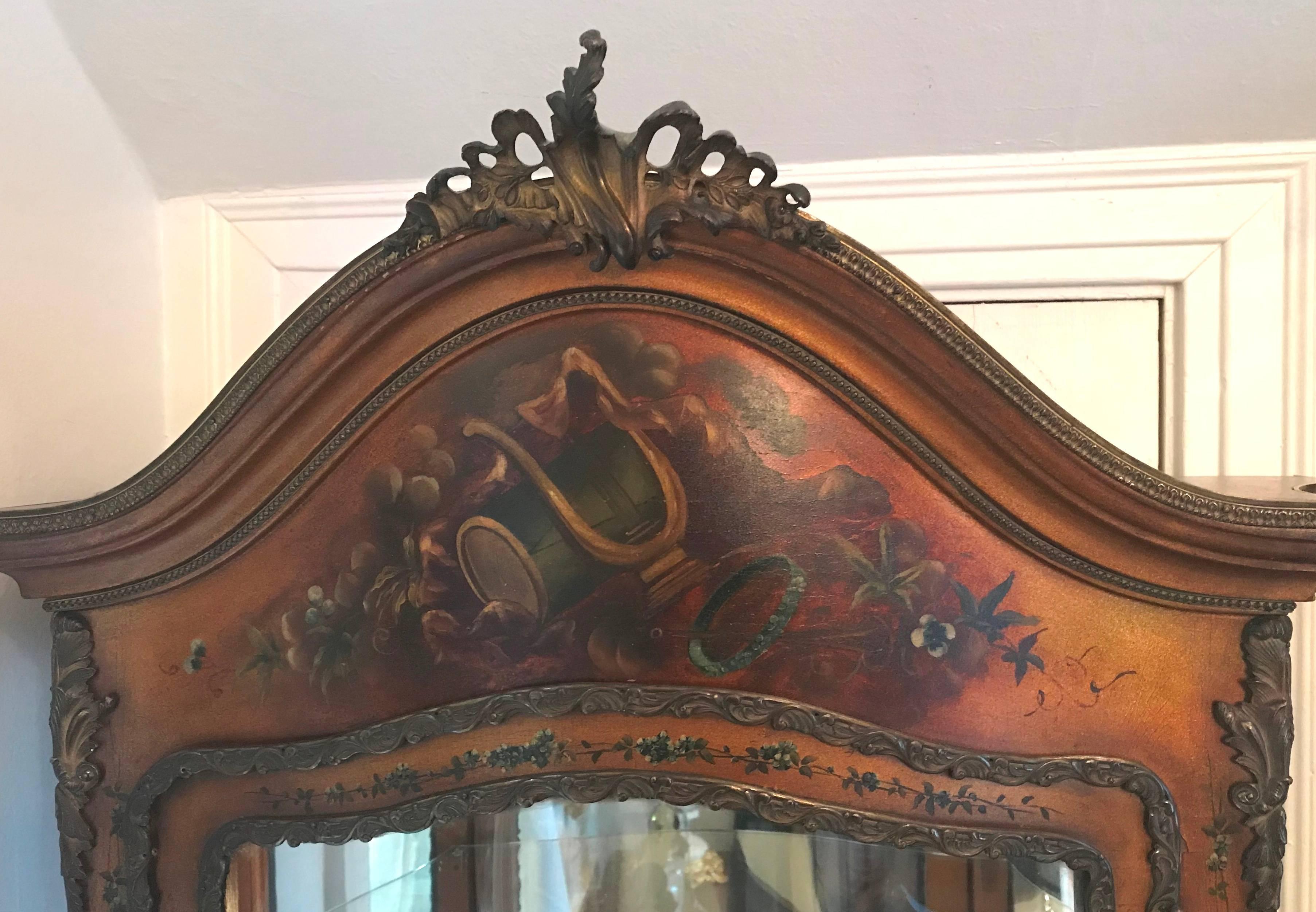 Lovely French vitrine cabinet. Single glazed door. Two glass interior shelves, velvet-lined bottom shelf, and lower cabinet section. Circa 1910.

Painted scene of lovers and musical instruments on front and landscape scenes on the sides.

Overall