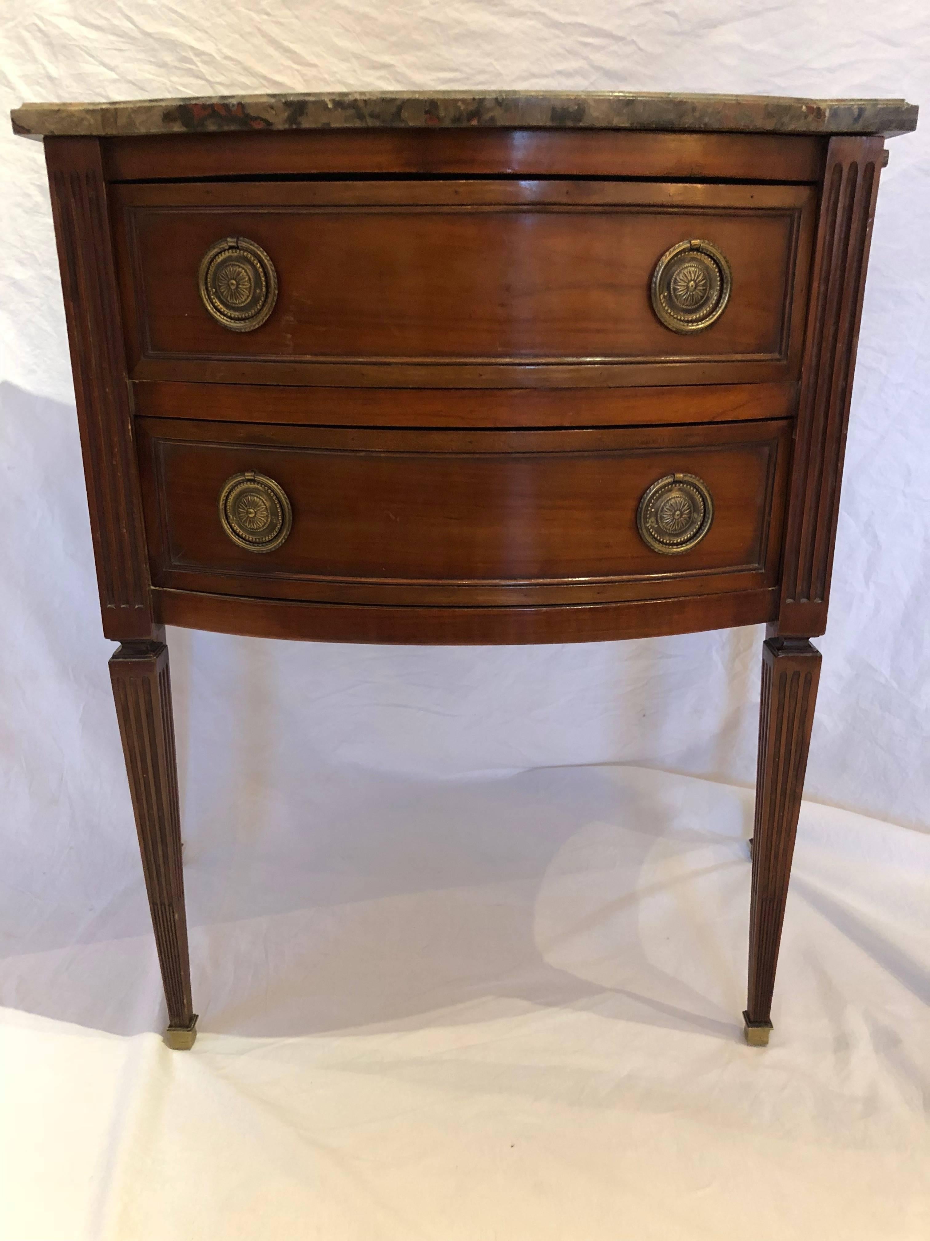 Handsome small commode with fluted legs, brass capped feet and a grey, tan, red marble top in original honed finish. The size is nice being larger than typical side table but smaller than a full sideboard or commode. 

Early 19th century 

Likely