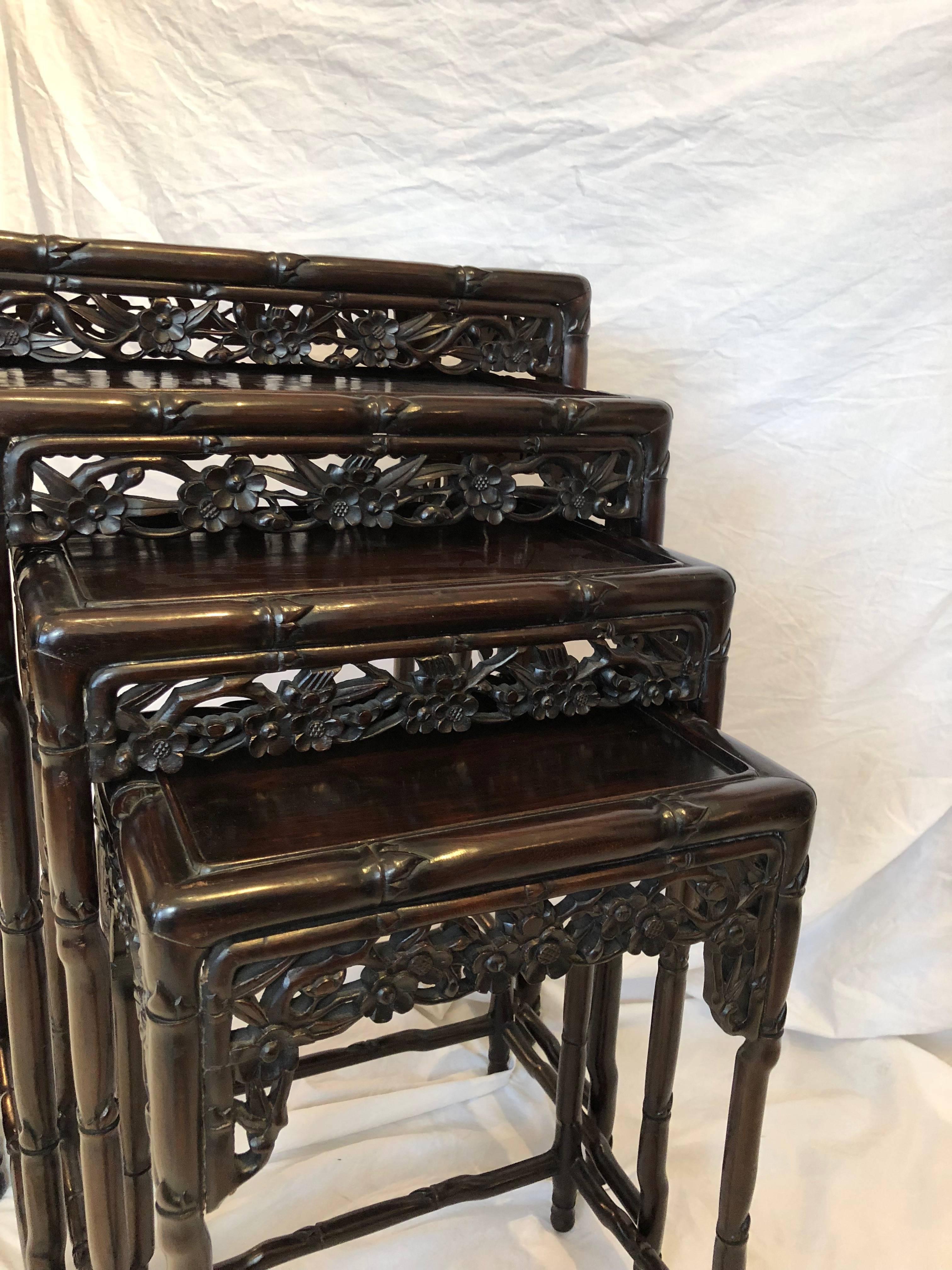 Set of four Chinese Rosewood nesting tables with floral motif skirts and bamboo style legs. 

Circa 1920

Largest table is 29" H, 14.5" D, 20.5" W 