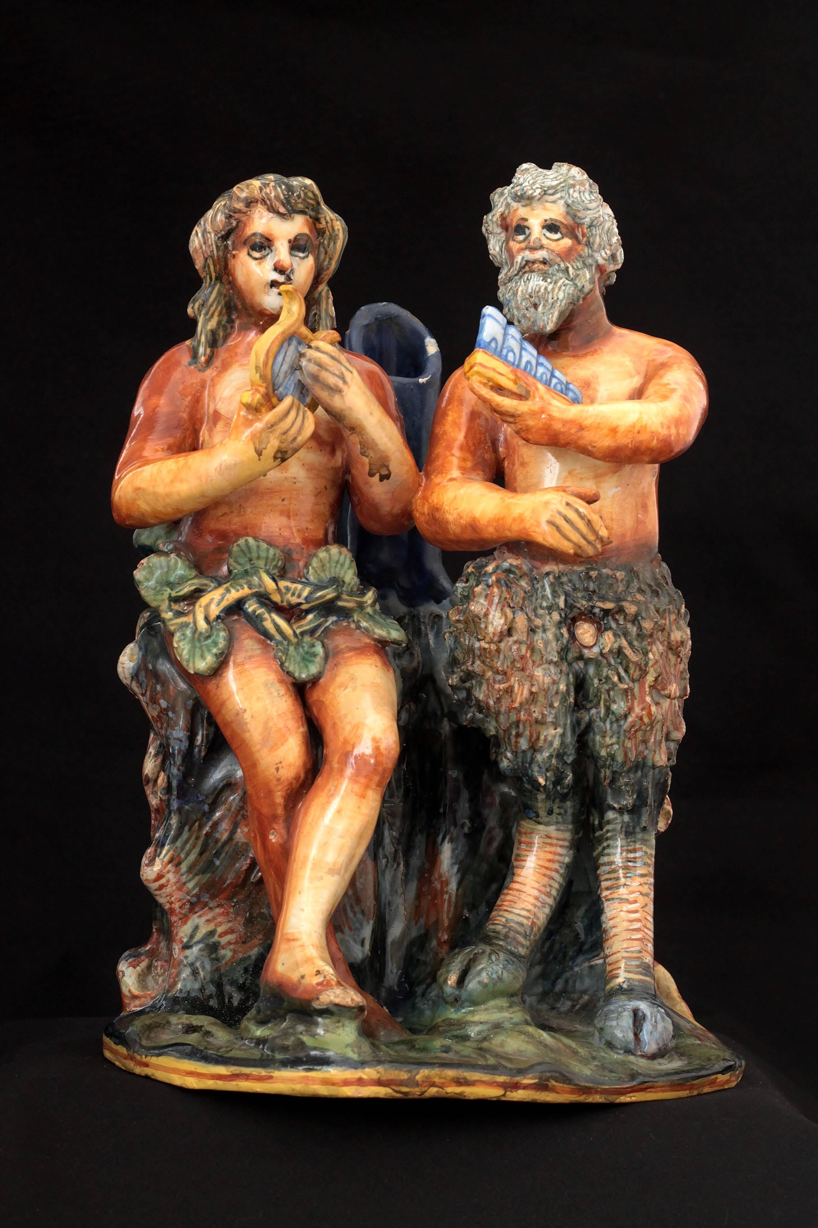 Originally modelled as a woman and a faun or a satyr playing lyre and pan pipe with naturals colors. End of 16th century.
Measures: Height 27.5 cm, width 19.5 cm, depth 15 cm
Some chips and lacks of enamel restored, base restuck, right hand of