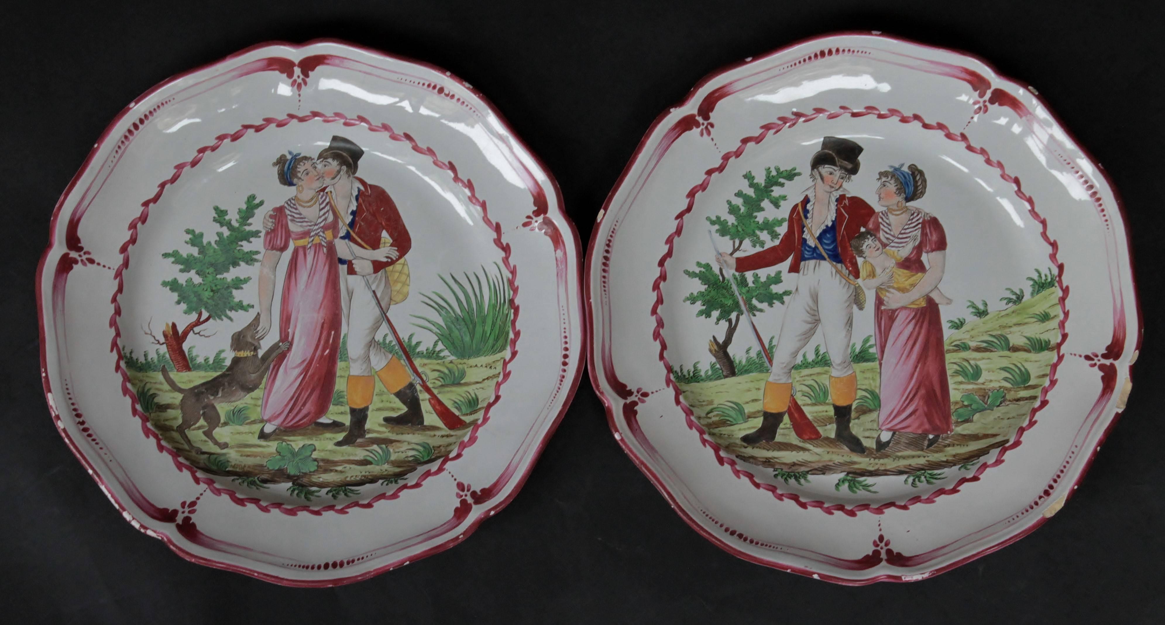 Pair of dishes decorated with a scene of two lovers in a rural setting, it’s a hunter holding a rifle and a bag and the woman with a recumbent dog, walking for the first dish and the same couple with a baby for the second dish. A band of purple