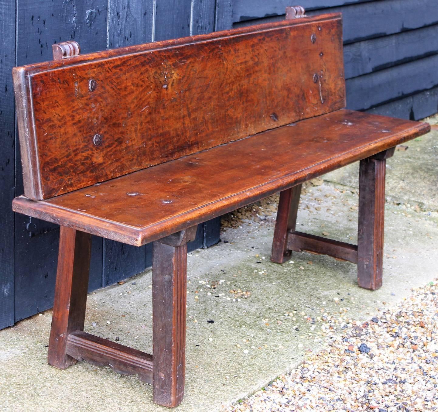 Good northern Italian walnut bench, with original iron or steel nails, of Primitive form but with some fluted details, good colour.