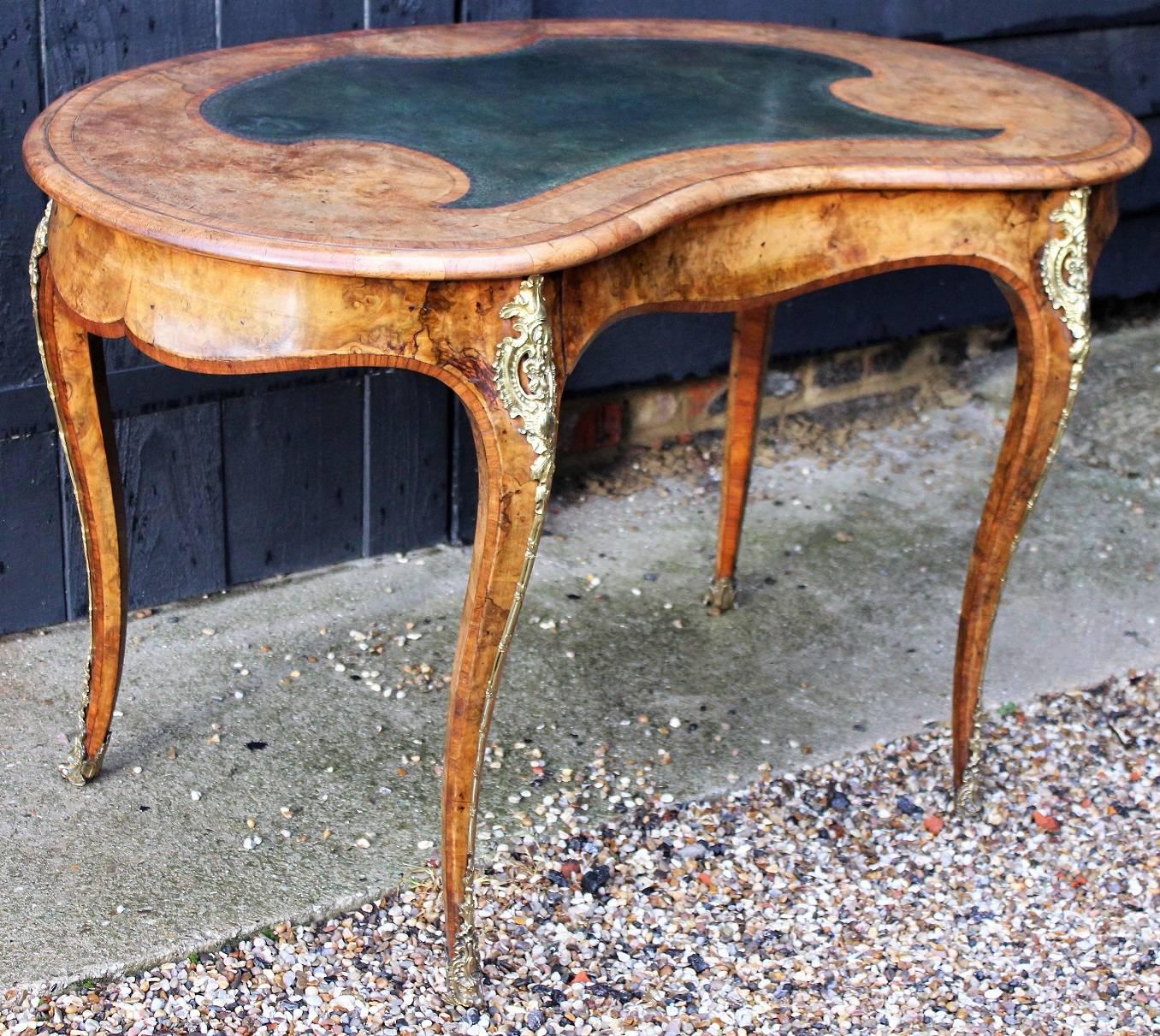 Fine Victorian Ladies writing table, in the French style, kidney shaped, walnut and rosewood crossbanded with ormolu mounts, fitted with a single drawer, circa 1870, attributed to Gillows.
This handsome piece was made to sit in the middle of the