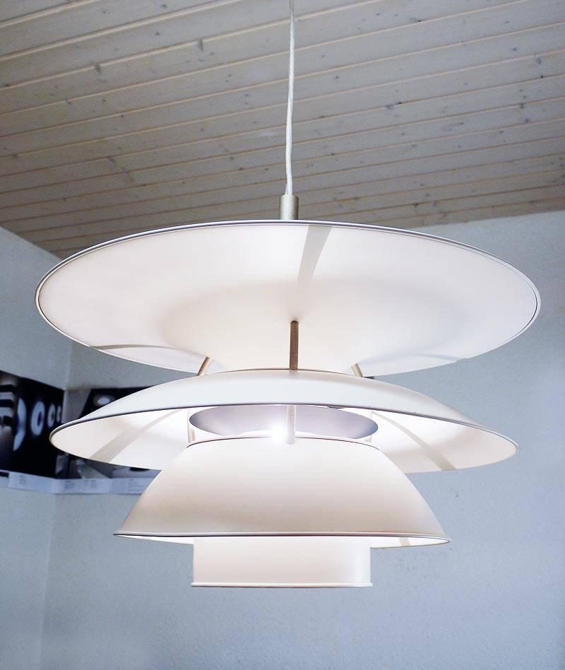 Large (PH 6½-6) pendant with white (and one blue) painted metal shades. Poul Henningsen designed the lamp for the Charlottenborg exhibition building in Copenhagen. Suitable for high and low mounting.
Max. 500W E40 Edison bulb.
   