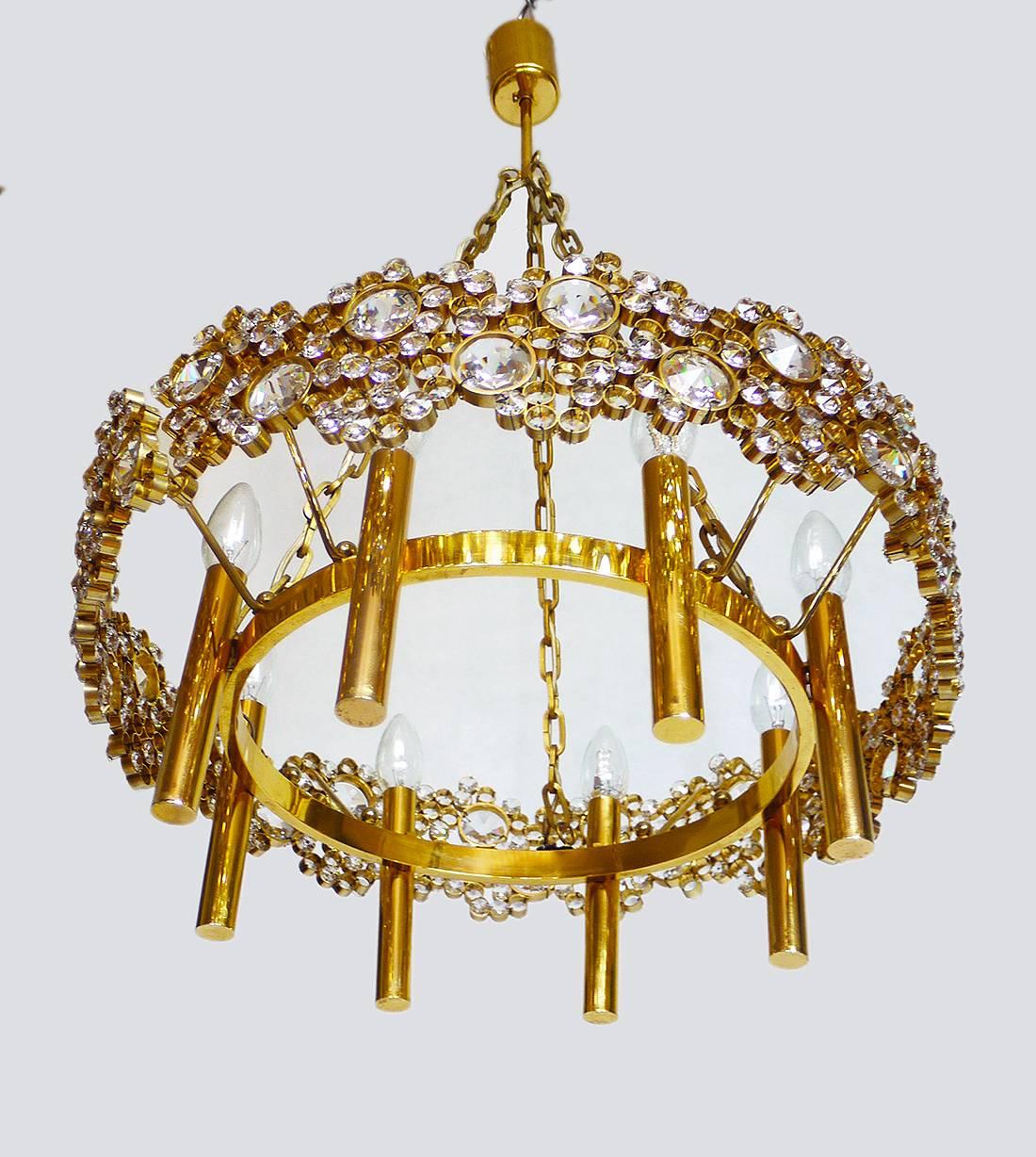 Elegant large and very impressive chandelier made of 24-karat gold-plated brass and hand polished crystal. Chandelier illuminates beautifully and offers a lot of light. Gem from the time. With this light you make a clear statement in your interior