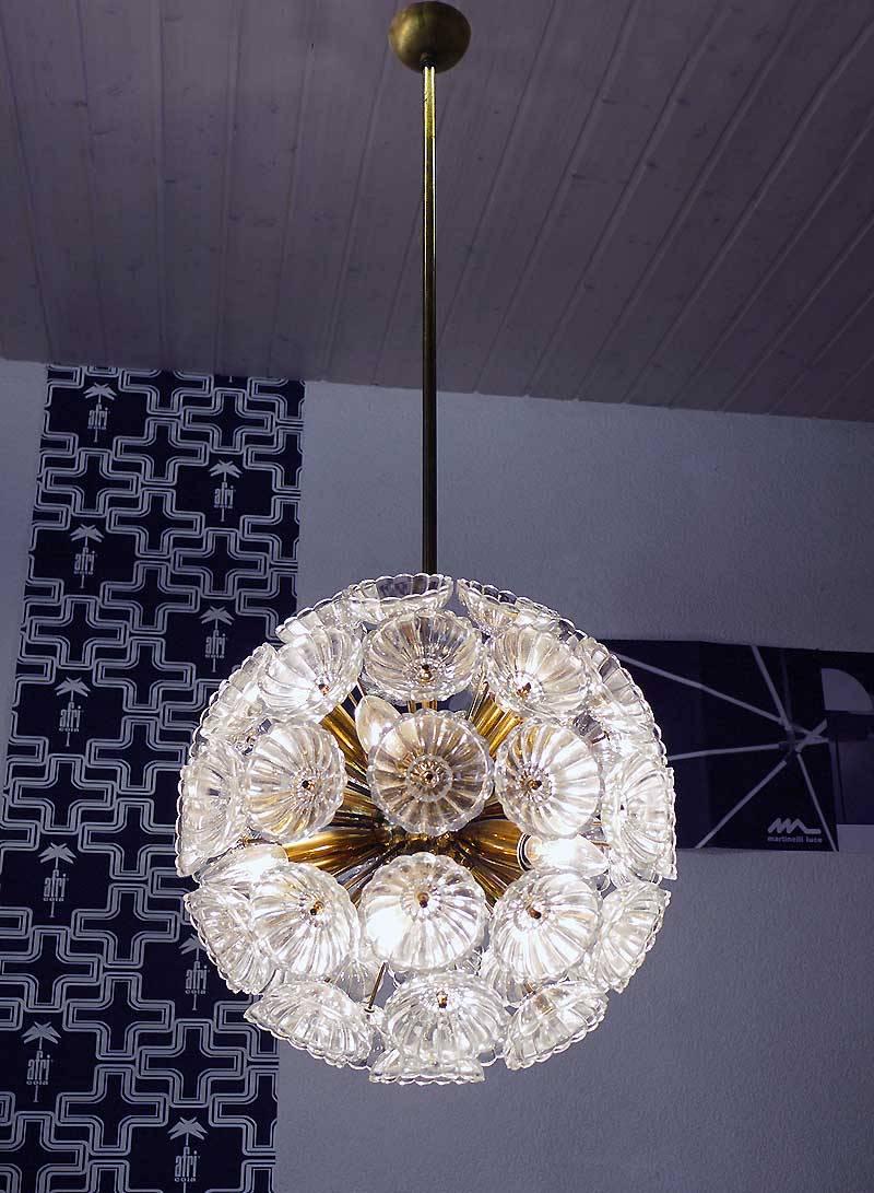 Elegant sputnik 'dandelion' chandelier with 52 glass flowers on a brass frame designed by Workshops Ebersbach. Chandelier illuminates beautifully and offers a lot of light. Gem from the time. With this light you make a clear statement in your