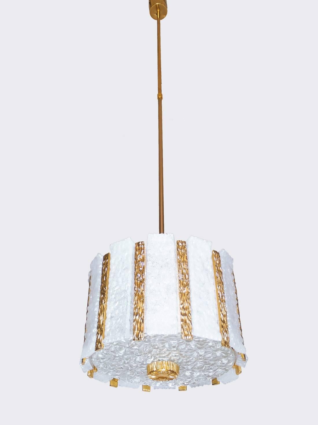 Gold-plated drum shaped chandelier with frosted glass panels on a gilt brass frame. Best of design from the 1960s by J.T. Kalmar, Austria.
The lamp takes 14 small E14 Edison base bulbs. 

The lamp has been tested with US American light bulbs under