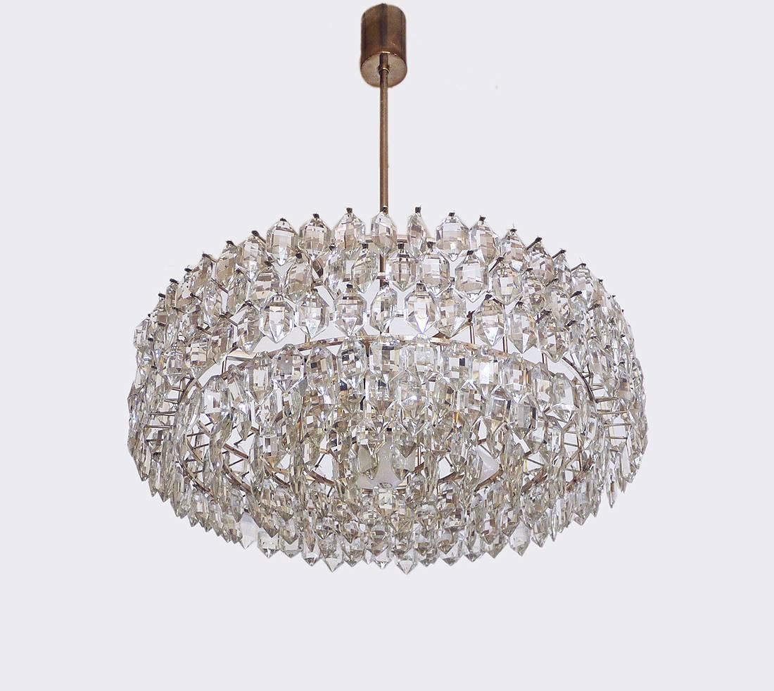 Large and very impressive chandelier with faceted crystals on a silver plated frame. Made in Austria in the 1960s.
The lamp takes seven large Edison base bulbs.
   