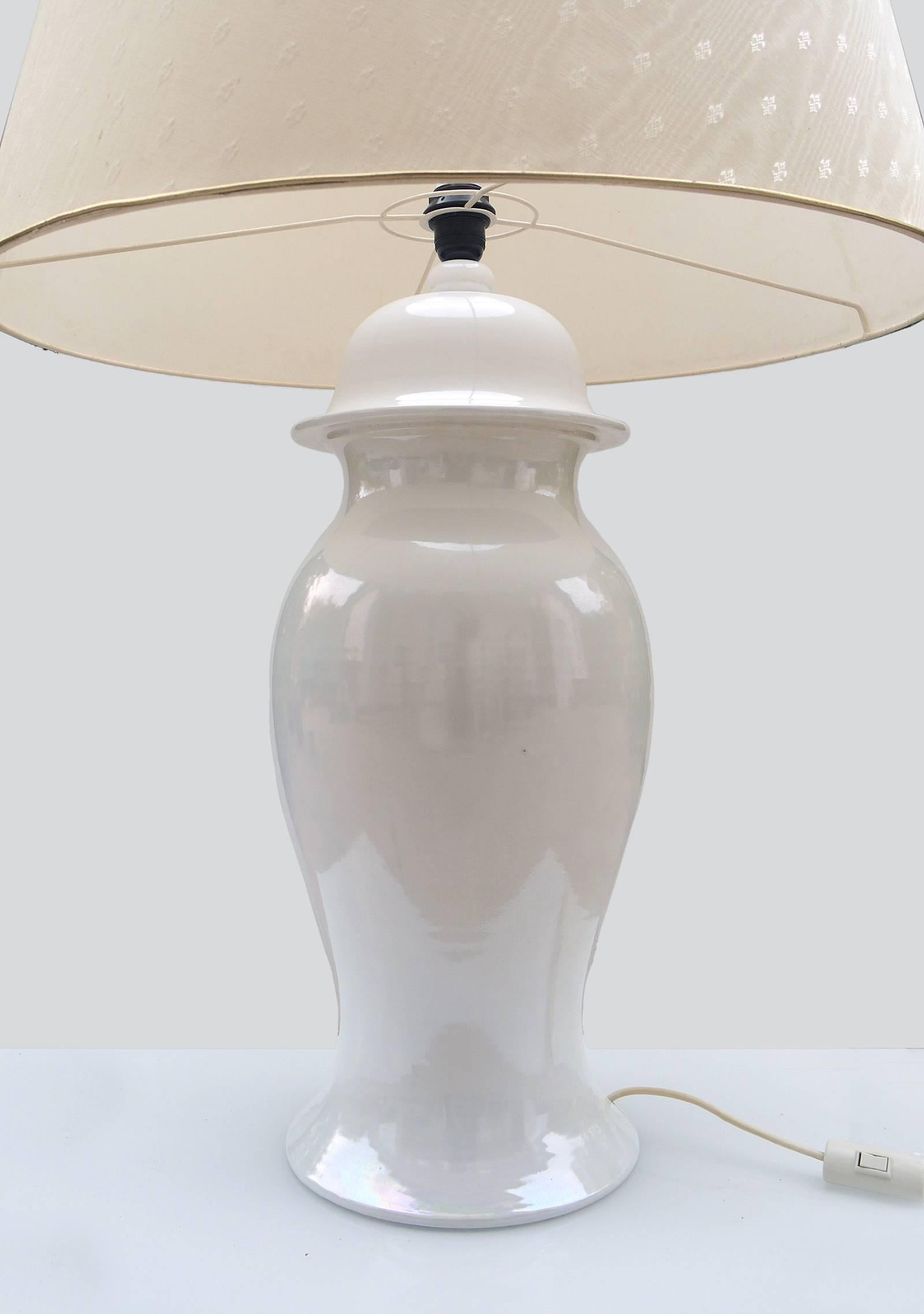 Elegant rare, huge Tommaso Barbi ginger jar ceramic lamp made in Italy in the 1960s. Crème ivory colored ceramic base, original fabric shade with emblem pattern. Signed at base. 
 
Measures: height including shade 41.3