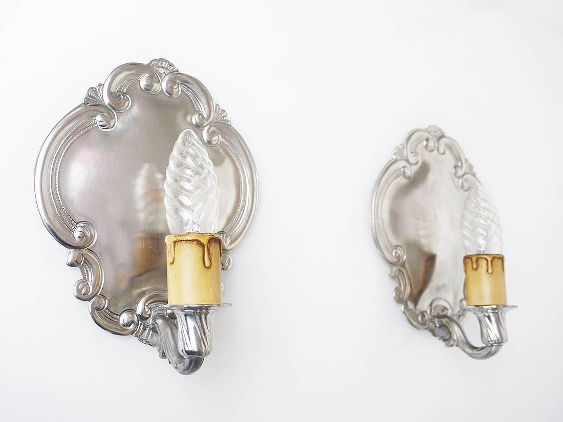 Pair of vintage pewter wall sconces made by August Weygang, Germany, circa 1900. August Weygang founded his pewter firm 1885. He cast pewter using traditional methods practiced for several hundred years. 

Many of his pieces made around the 1900