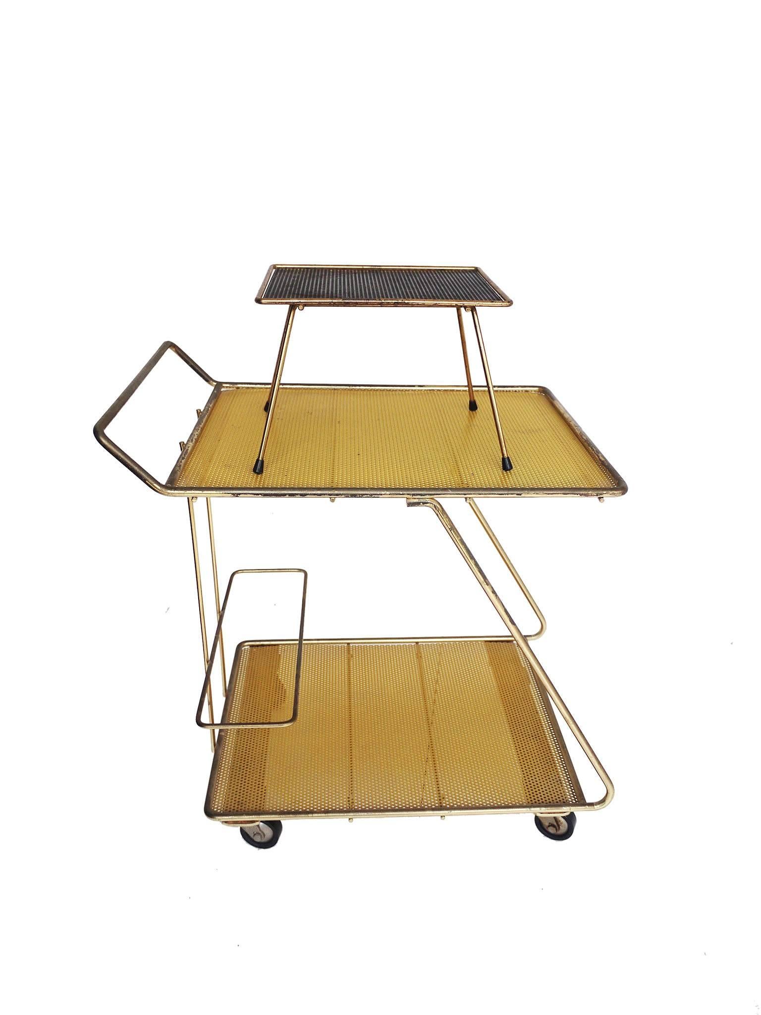Bar trolley, magazine Stand and a small side table made of perforated metal and brass by Mathieu Mategot in the 1950s.
Extraordinarily good condition with a beautiful patina.
The casters of the trolley were probably replaced.
Trolley: W