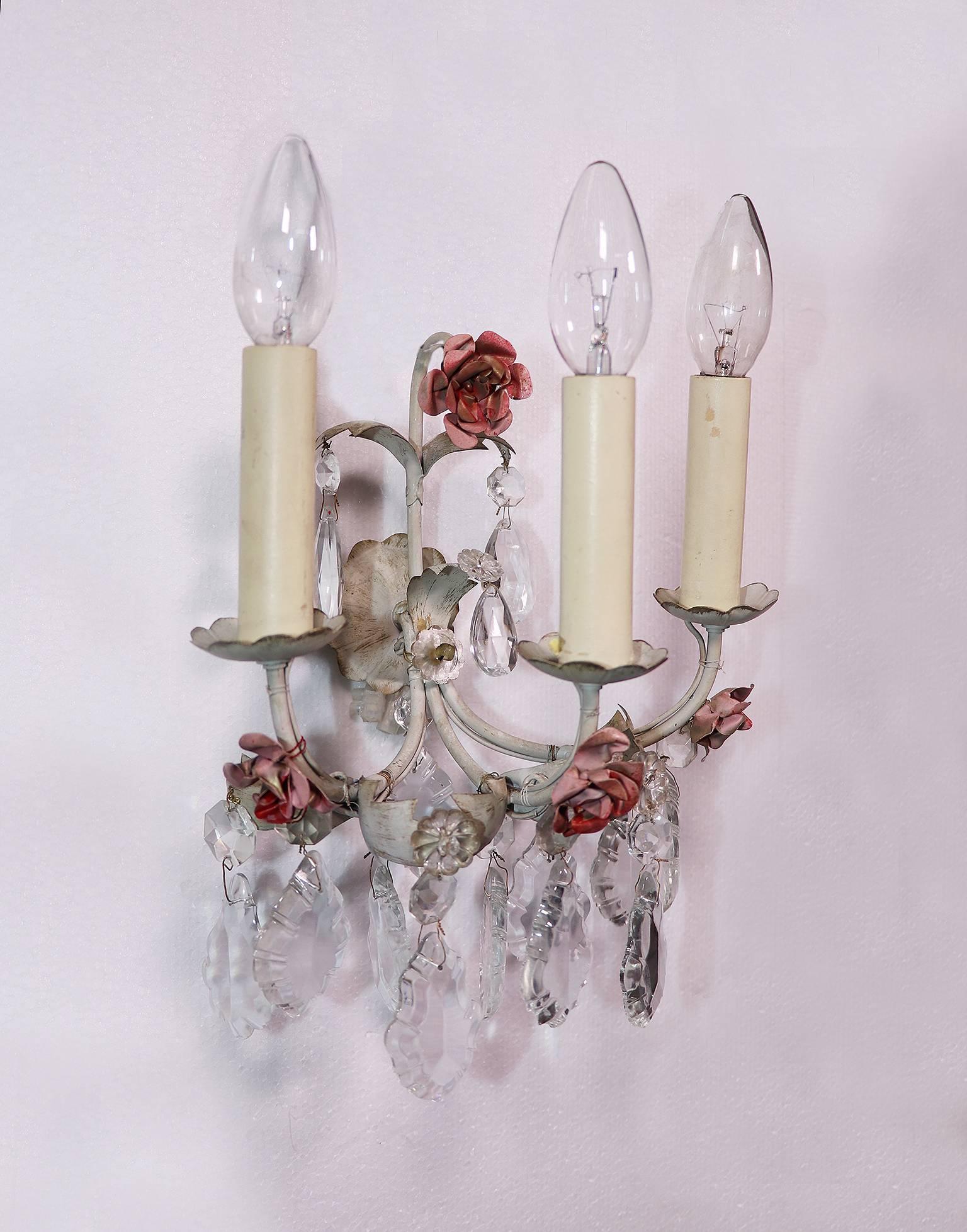 Pair of tole wall sconces with painted metal flowers and rock crystals made in Italy in the 1940s. 

Lighting: takes three small Edison E14 base bulbs per lamp. 

Delivery without bulbs. 
