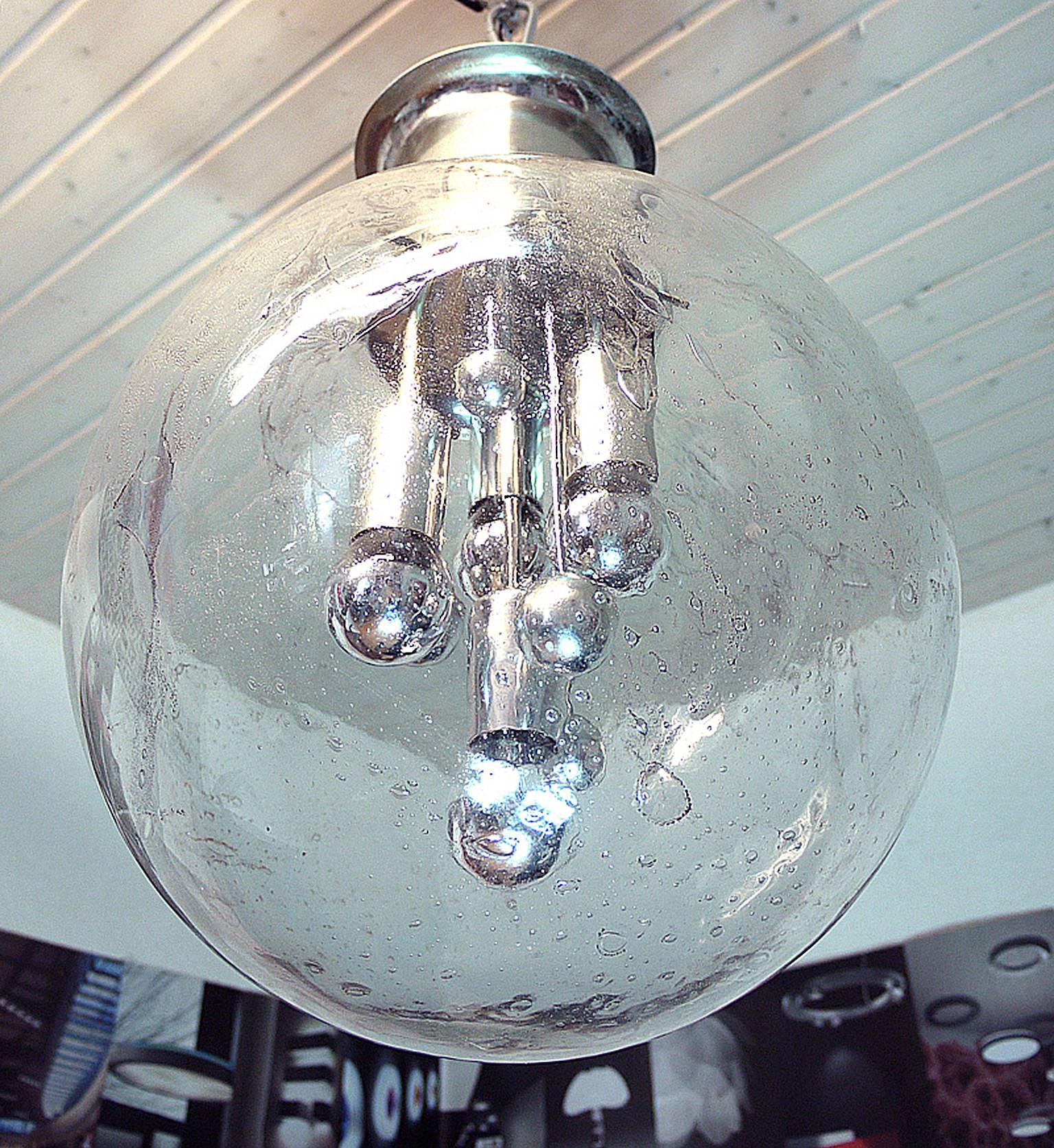 Amazing high quality Sputnik flush mount ceiling light 'Big Ball' with a heavy, lava-like hand blown bubble glass ball on a chromed base. Inside the lamp there are chrome spheres of different sizes, reminiscent of planet. Heavy design. A real design