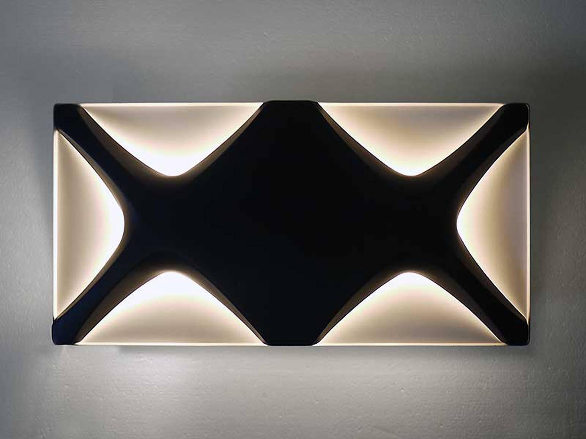 Very rare oyster wall lamp by Dieter Witte and Rolf Krüger for Staff, Germany, 1968. Black and white enameled metal. 

Lighting: takes two large Edison E14 base screw bulbs. 
Wattage: we recommend up to 60w per bulb. Works on 220v as well as 110v.