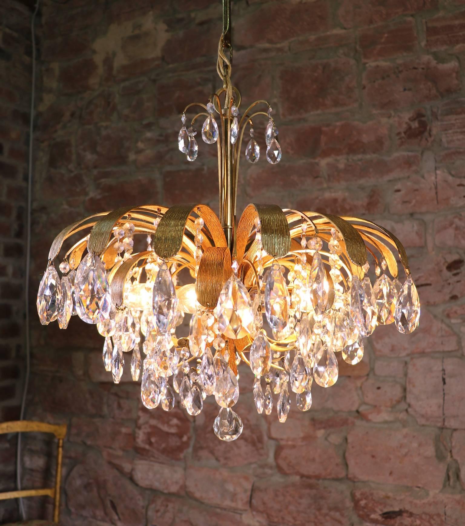 Beautiful cascading gilt brass leaf crystal chandelier made by Palwa, Germany in the 1960s.
Original wiring with 8 small Edison bulbs.