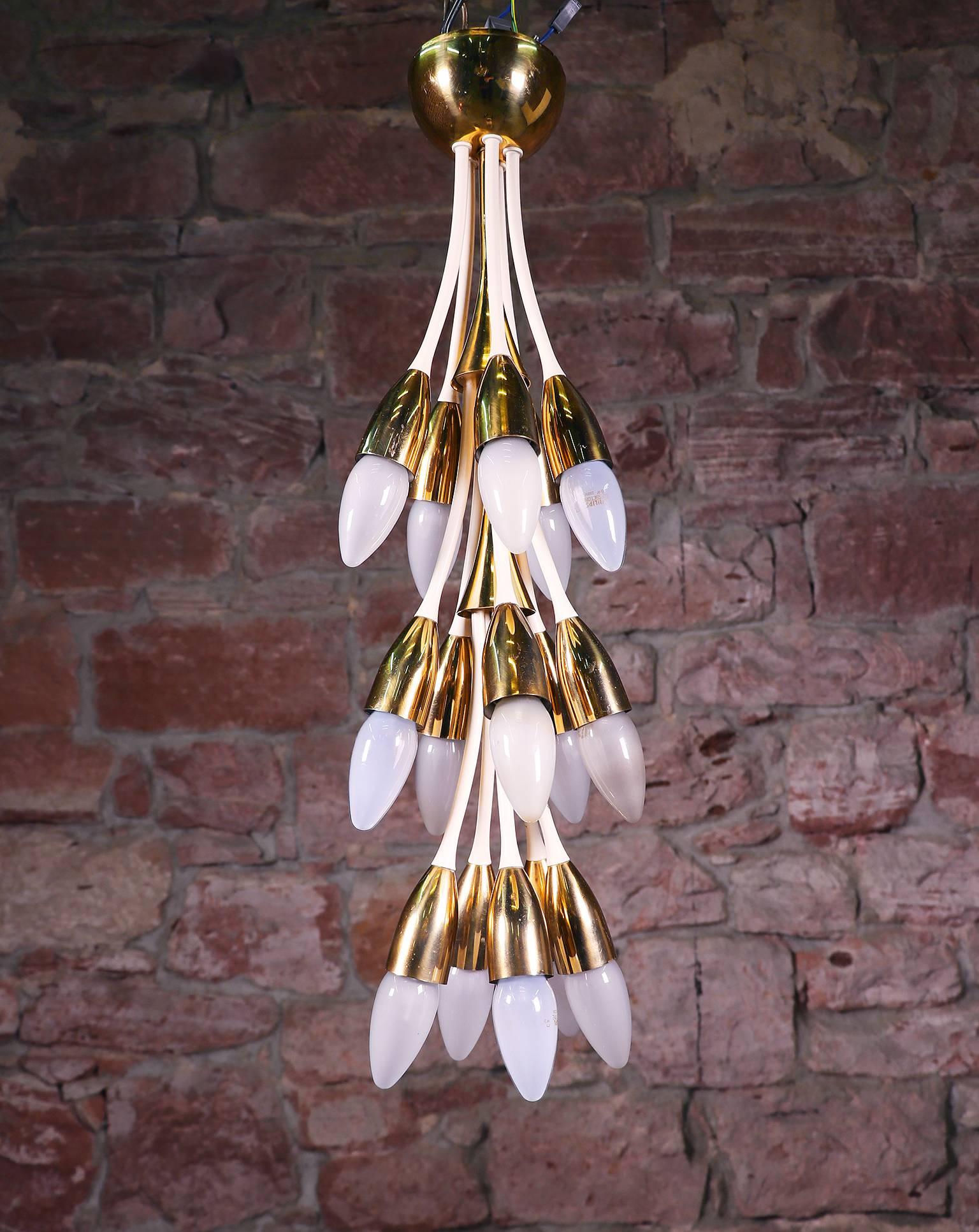 Impressive mid-century twelve-light chandelier with enamel curved arms and polished brass cones, attached to a flushed canopy mount. Manufactured in Italy in the style of Stilnovo, 1950s. 

Design: Stilnovo attr. 
Lighting: takes twelve small Edison