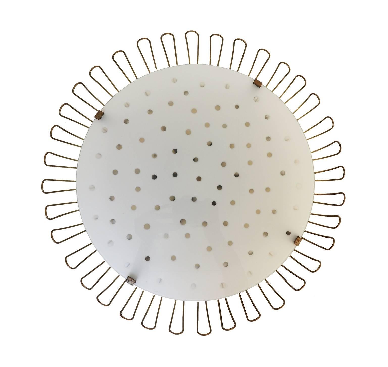 Beautiful and unique mid century modern sunflower ceiling and wall light with a glass cover plate with transparent dots, surrounded by brass wired petals on a perforated metal frame. Designed by Karl Walther. Manufactured by Kurt Kaiser, Germany in