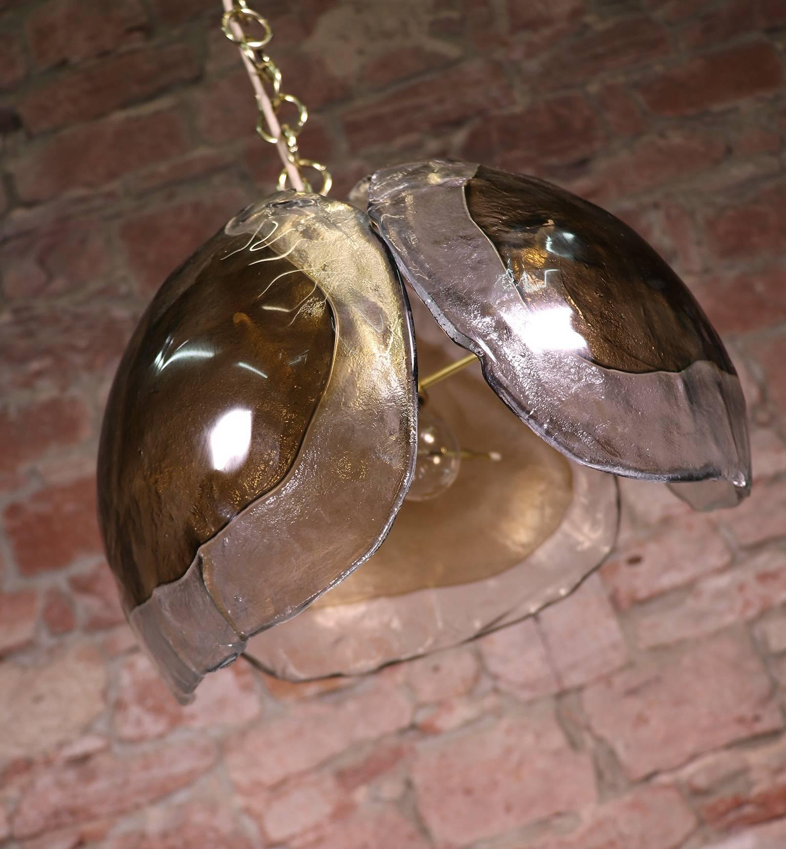 Elegant pendant lamp with three large thick curved amber Murano glass elements on a brass frame. Made in the 1960s by Kaiser Lighting, Germany. 

Measures: height without suspension: 11.8