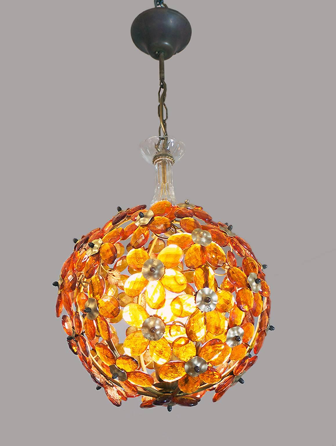 Elegant mid century globe chandelier with molded amber glass flowers and leaves on a brass frame. Manufactured by Maison Bagues, France in the 1950s.

Lighting: takes one large Edison E27 base screw bulb. 
Wattage: we recommend up to 75w per bulb.