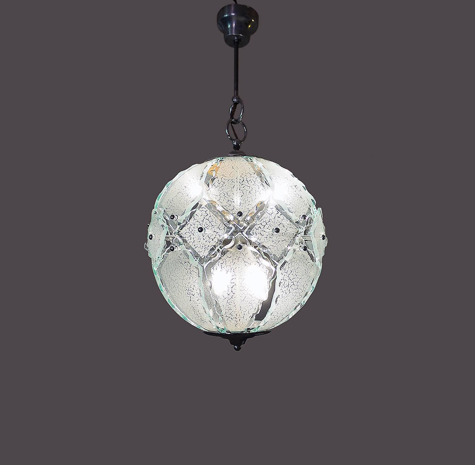 Elegant spherical glass chandelier by O4 (Zero Quattro) edited by Fontana Arte, Milano, Italy in the 1970s. Made with elements of cut Murano glass and a chromed sputnik frame. Zero Quattro was a very small company based in Milan, Italy. 

Lighting: