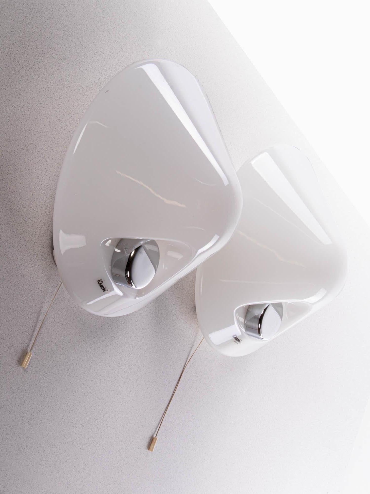 Elegant pair of space age wall lights with white plastic lampshades mounted with chromed metal buttons. Designed and manufactured by iGuzzini, Italy in the 1970s. 

Measures: diameter 12